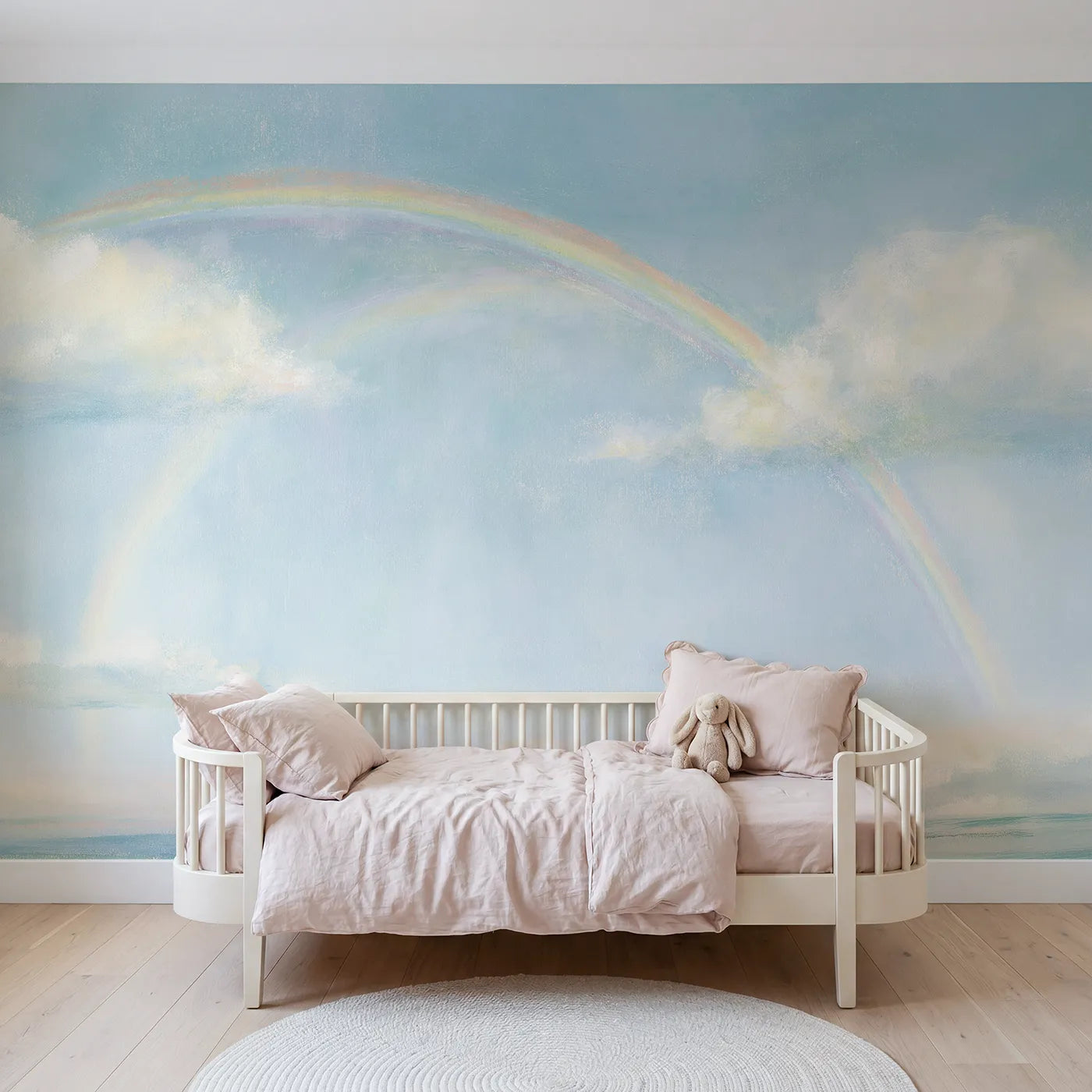 Chalk-pastel wall mural of a tender pastel rainbow by Whimsy Tots