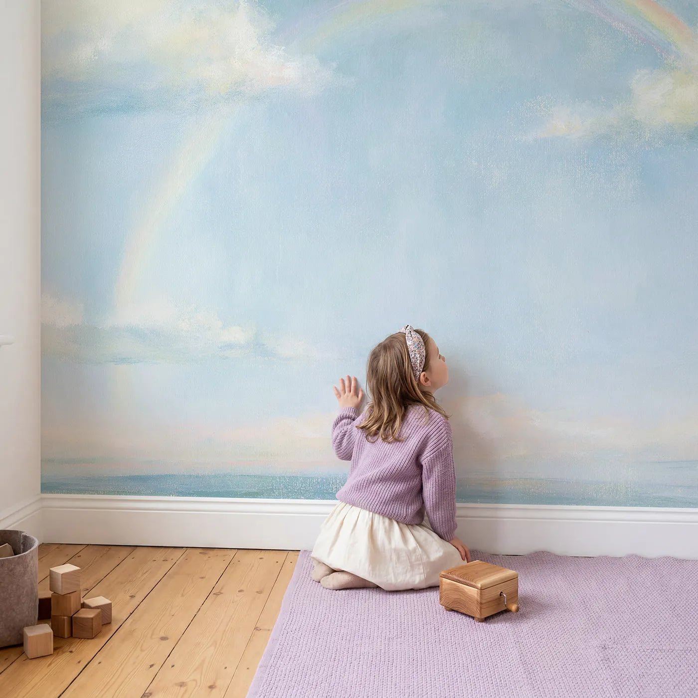 Child in nursery with Pastel Rainbow Dream Wallpaper Mural by Whimsy Tots