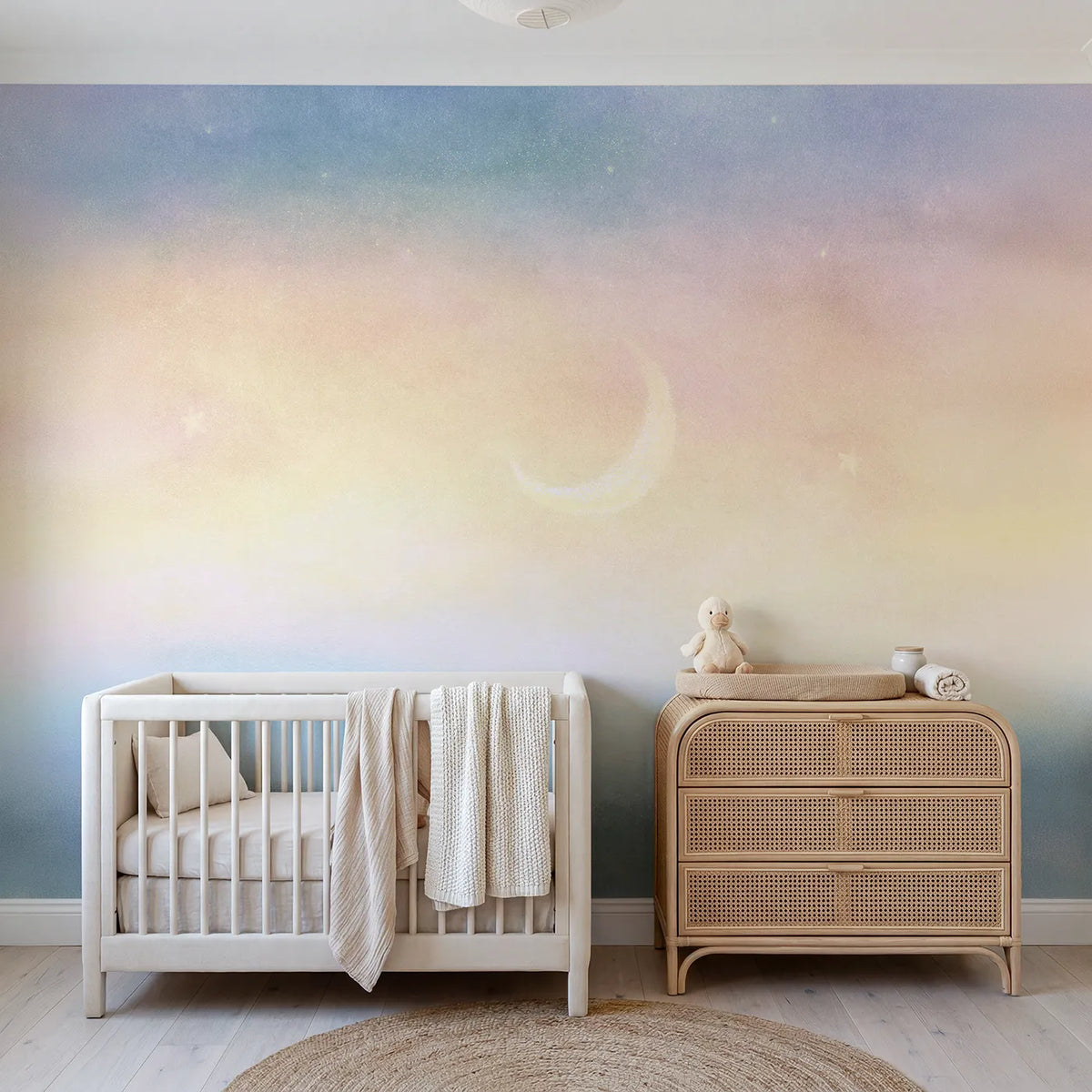 Chalk-pastel wall mural of a pastel crescent and stars by Whimsy Tots