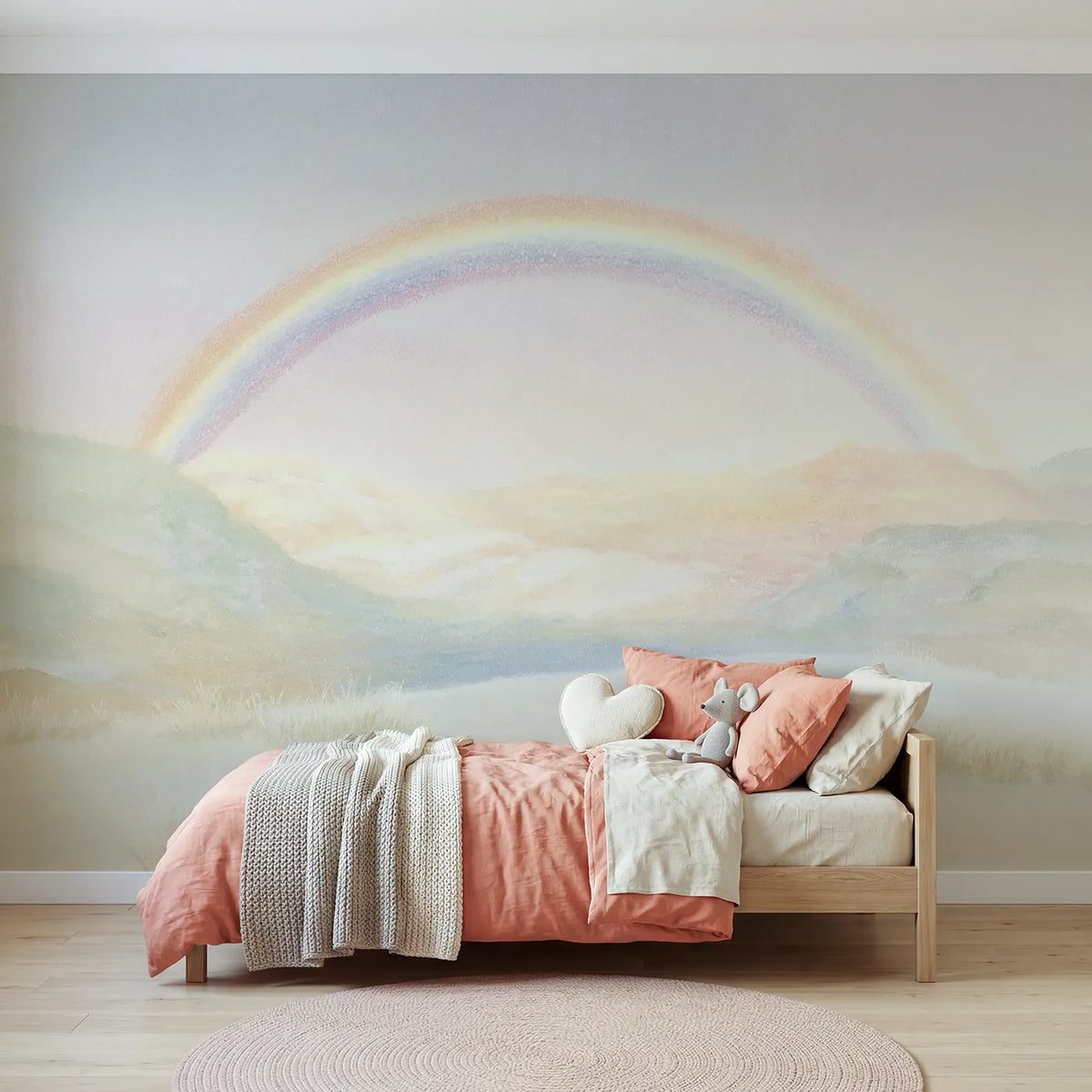 Chalk-pastel wall mural of a rainbow over pastel hills by Whimsy Tots