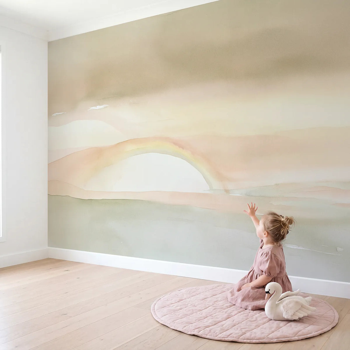 Child in nursery with Soft Nursery Rainbow Wallpaper Mural by Whimsy Tots