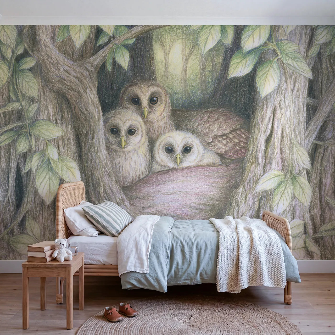 Colored-pencil wall mural of an owl family in a hollow by Whimsy Tots