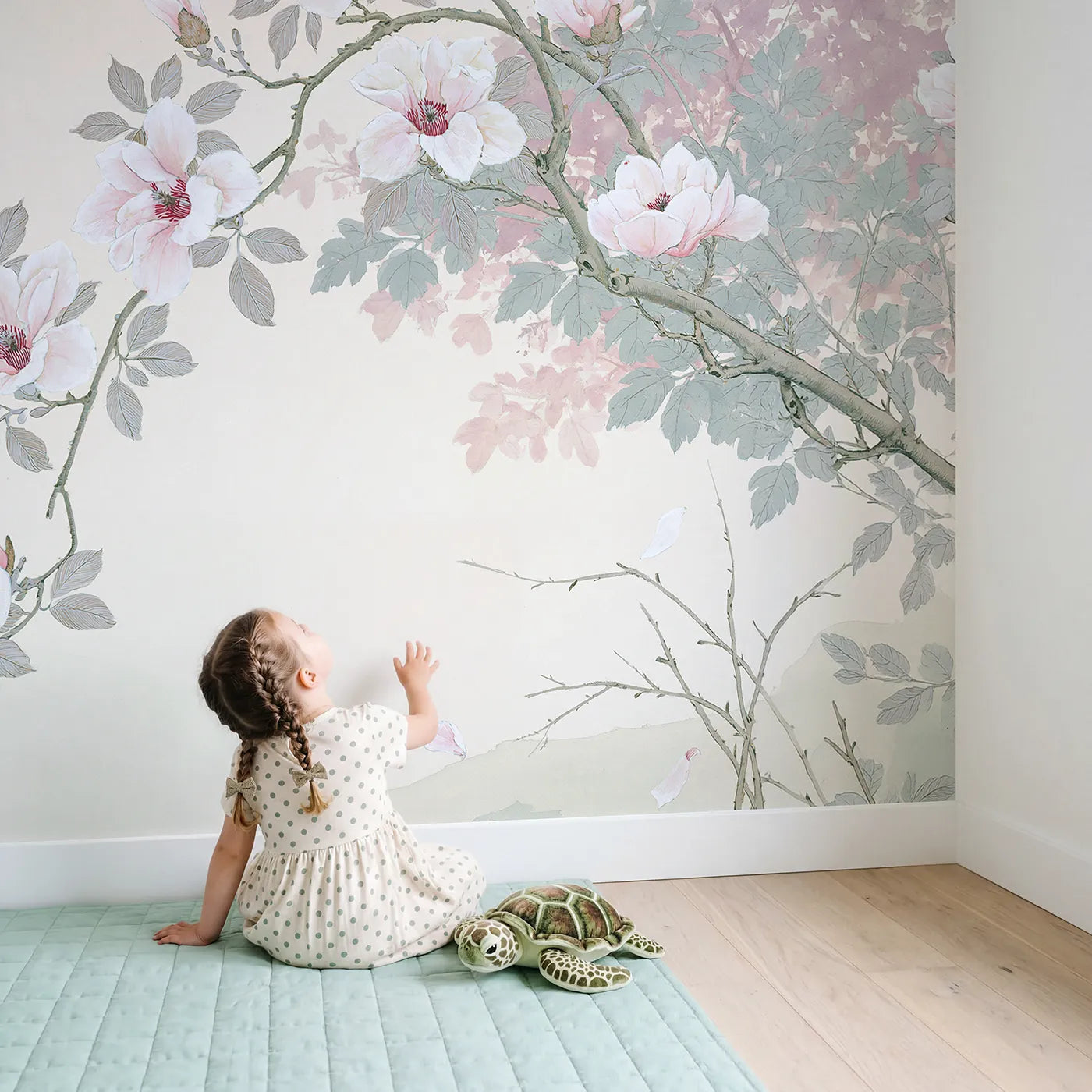 Child in nursery with Magnolia Branch Bloom Wallpaper Mural by Whimsy Tots