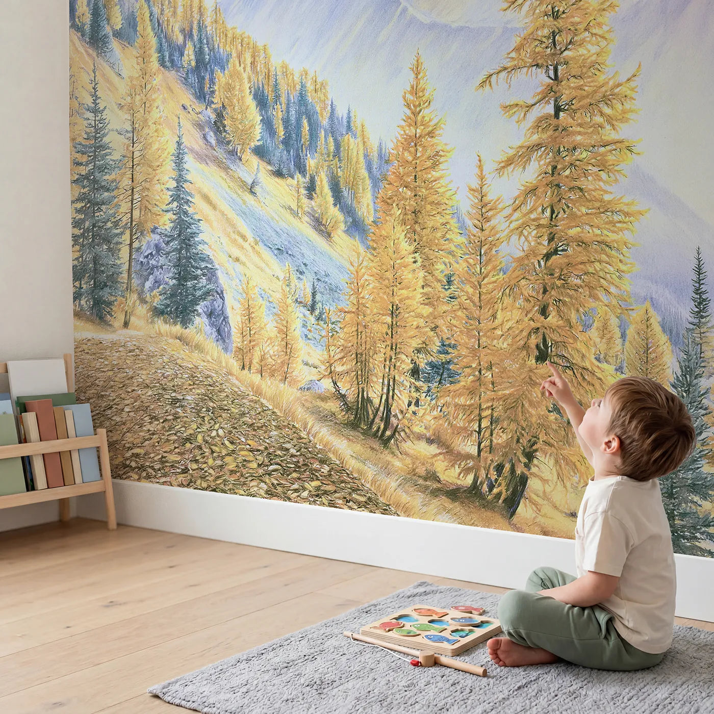 Child in nursery with Autumn Larch Slopes Wallpaper Mural by Whimsy Tots