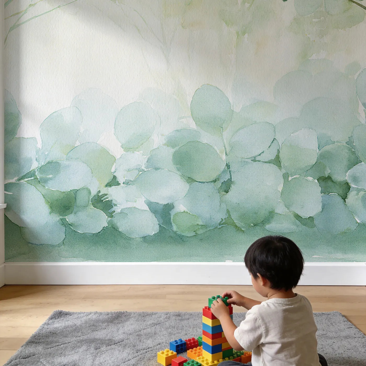 Child in nursery with Soft Eucalyptus Haze Wallpaper Mural by Whimsy Tots