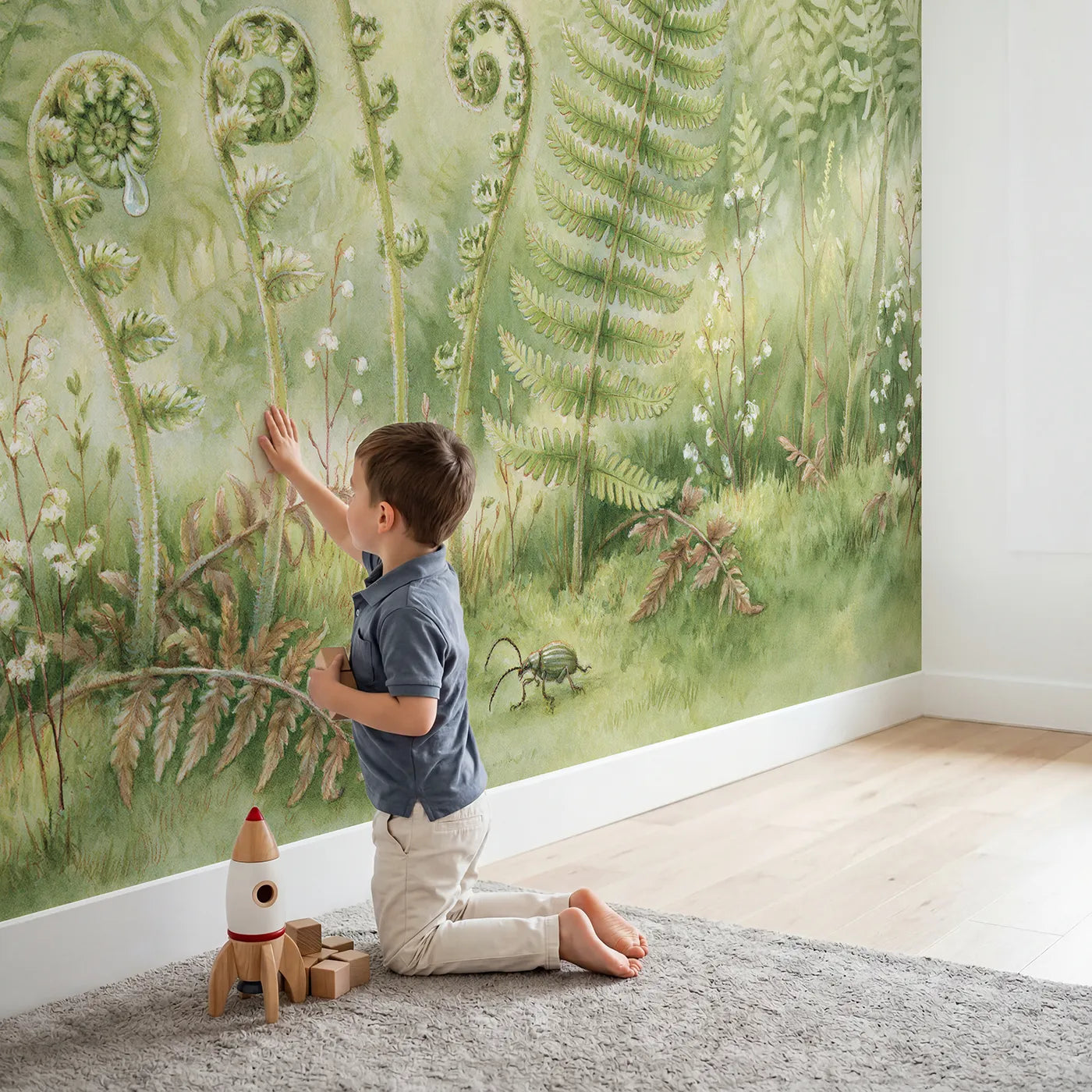 Child in nursery with How a Fern Unfurls Wallpaper Mural by Whimsy Tots