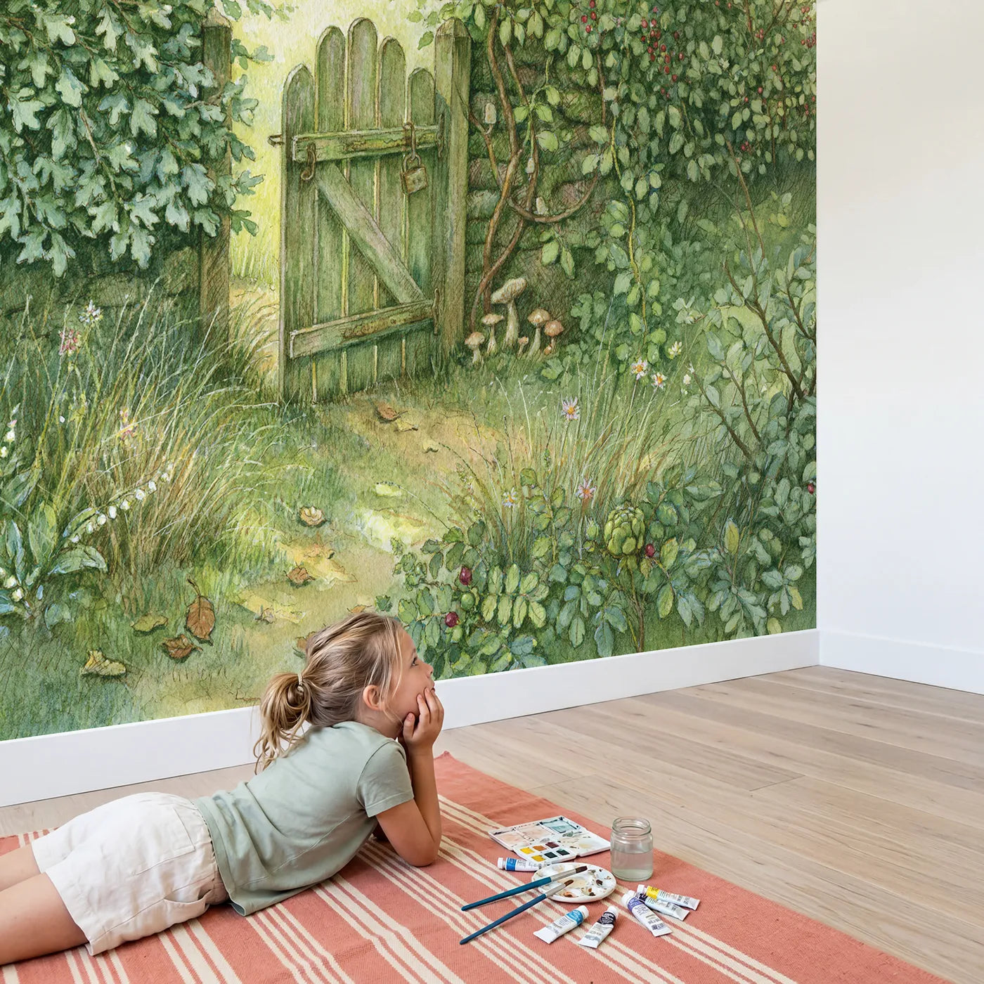 Child in nursery with Snug Garden Gate Wallpaper Mural by Whimsy Tots