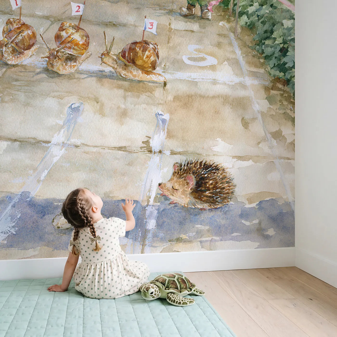 Child in nursery with The Great Snail Race Wallpaper Mural by Whimsy Tots