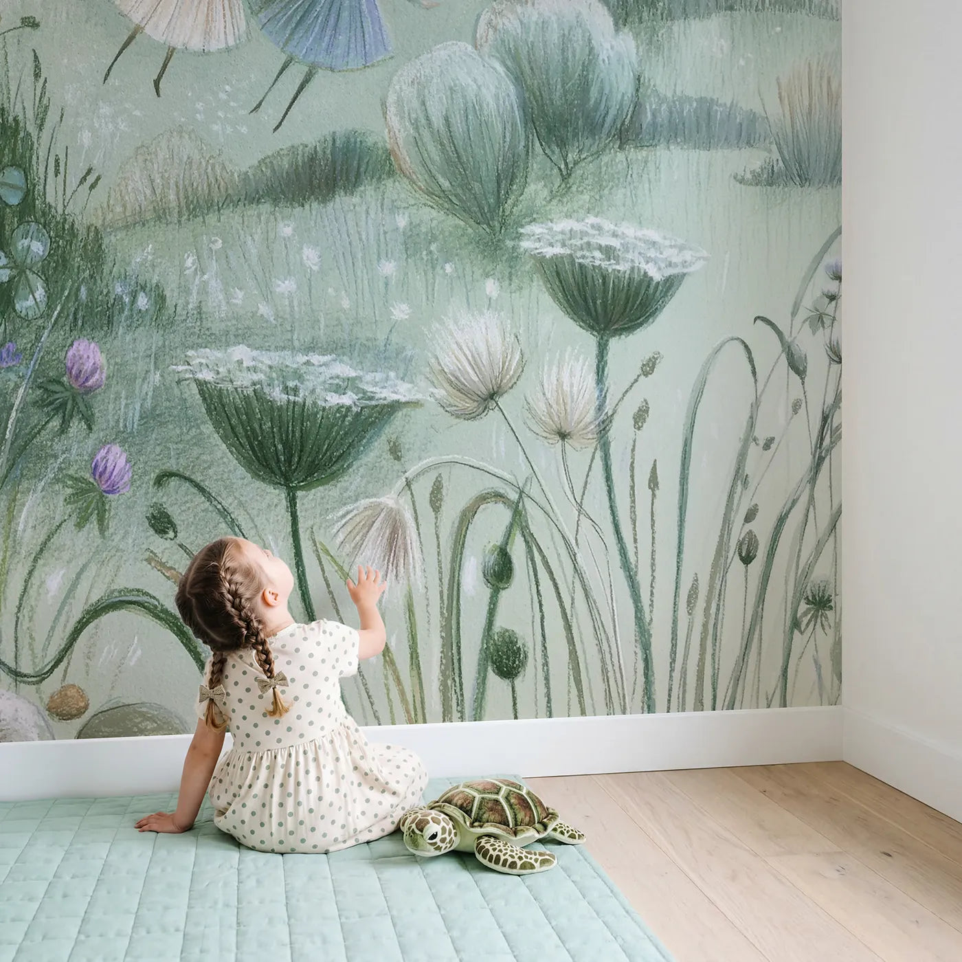 Child in nursery with Soft Pixie Meadow Wallpaper Mural by Whimsy Tots