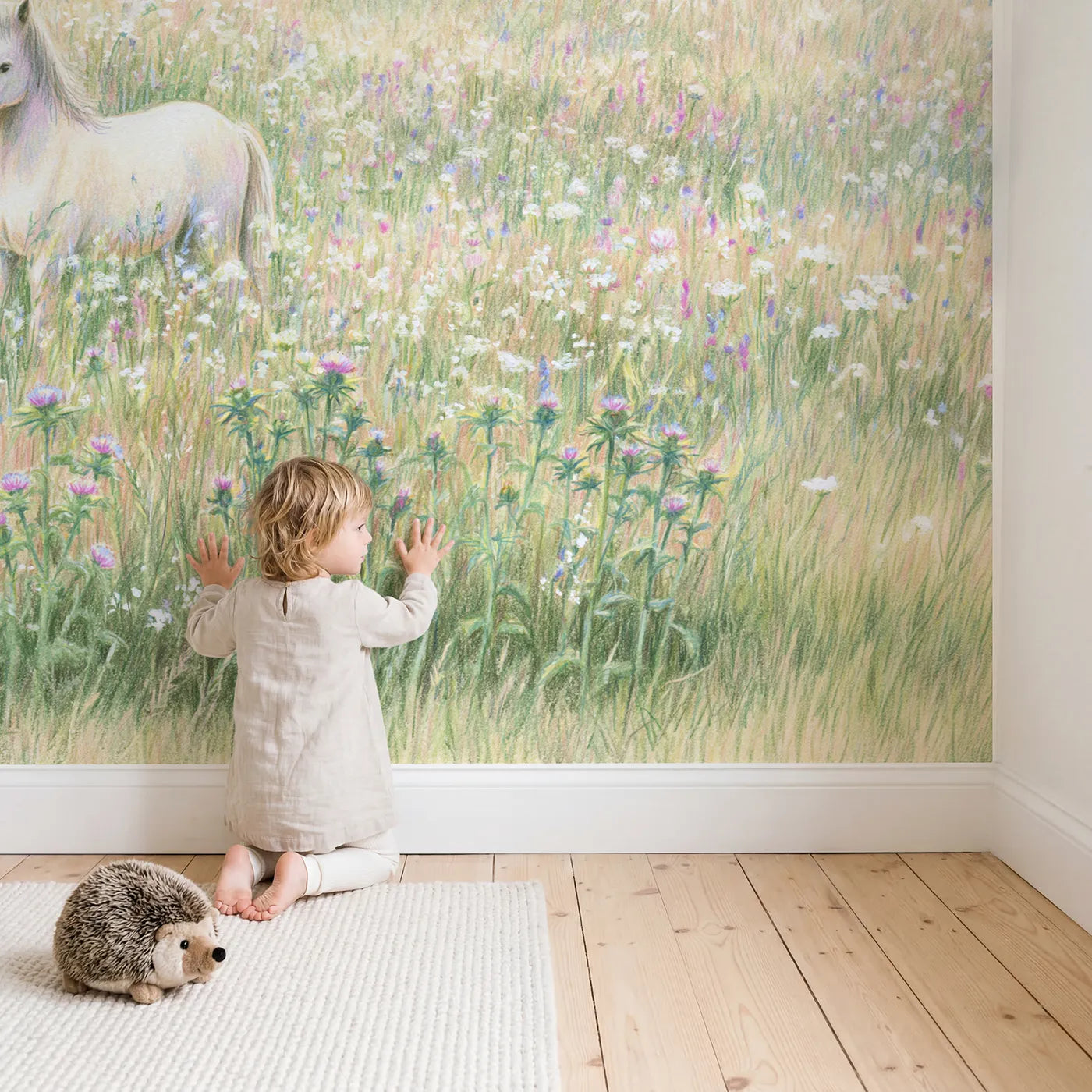 Child in nursery with Unicorn Among Flowers Wallpaper Mural by Whimsy Tots