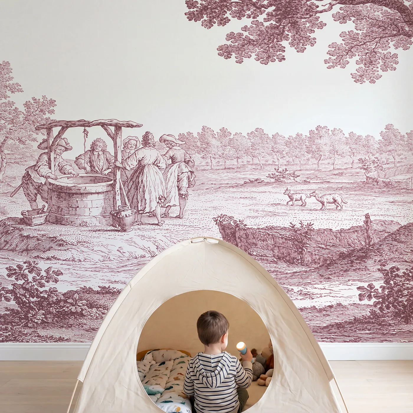 Child in nursery with Village Well Gathering Wallpaper Mural in Pink by Whimsy Tots