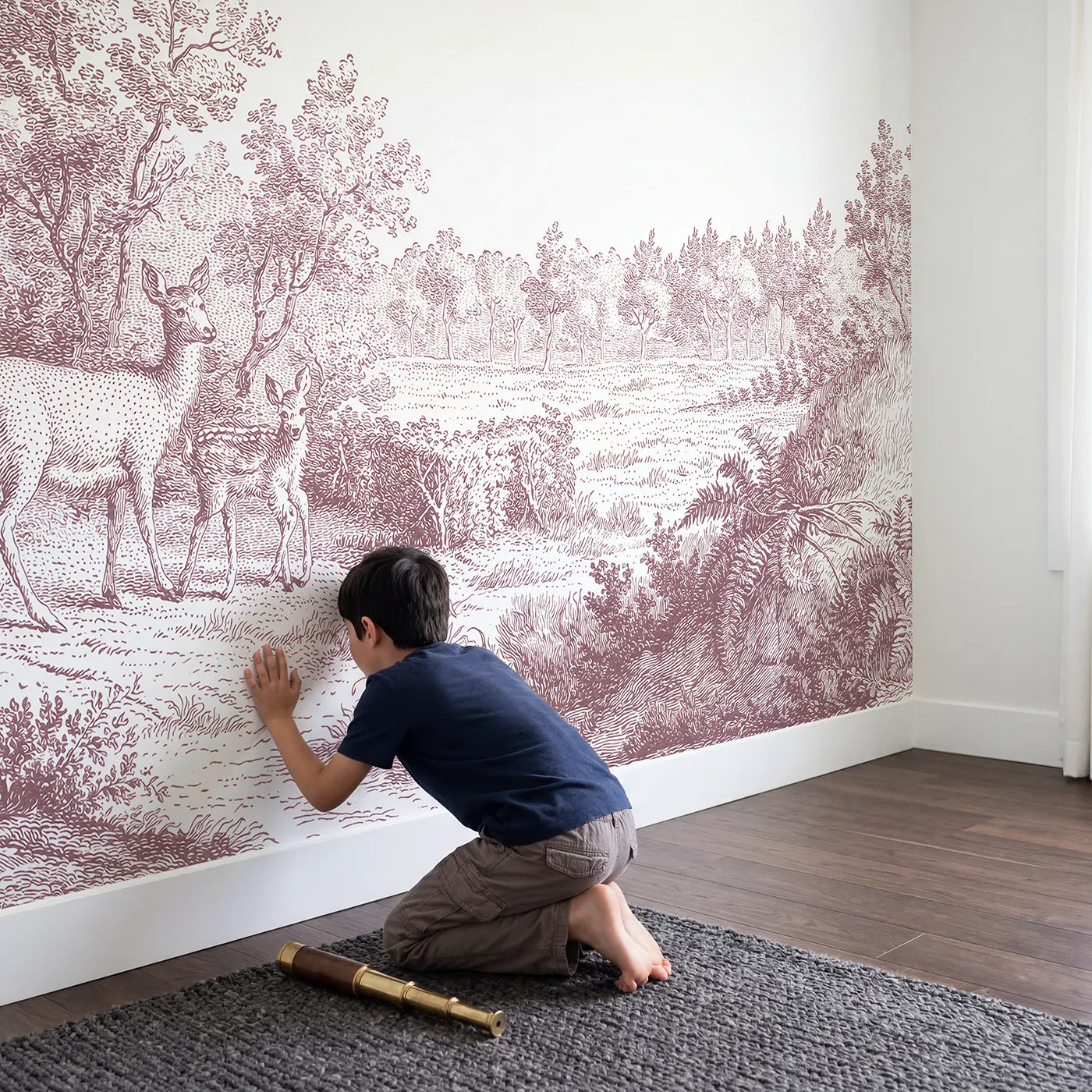 Child in nursery with Doe And Fawn Wallpaper Mural in Pink by Whimsy Tots
