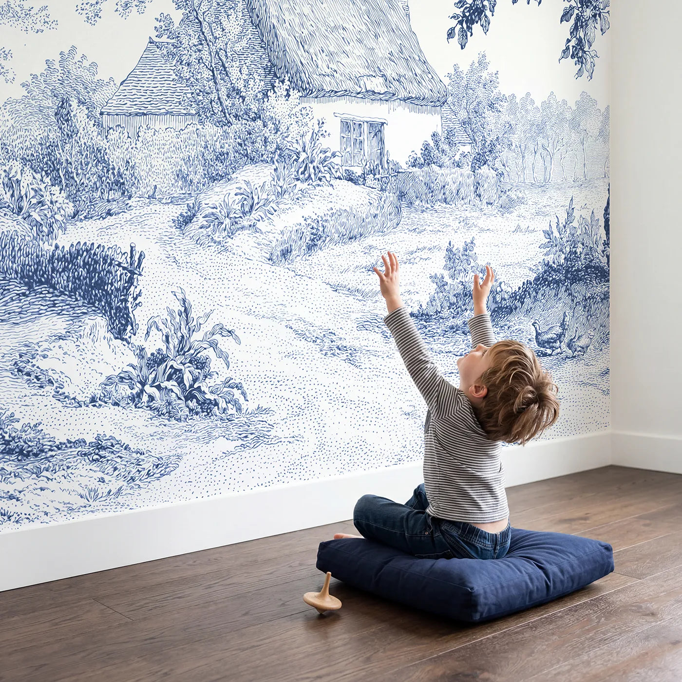 Child in nursery with Thatched Cottage Lane Wallpaper Mural by Whimsy Tots