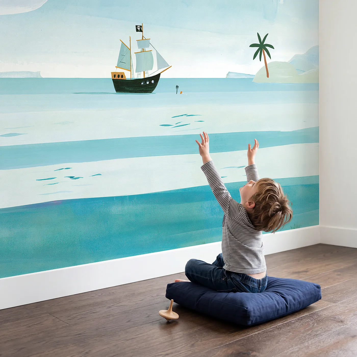 Child in nursery with Folk Pirate Ship Wallpaper Mural by Whimsy Tots