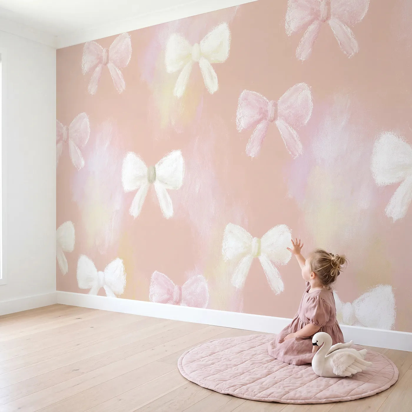 Child in nursery with Scattered Bows Wallpaper Mural by Whimsy Tots