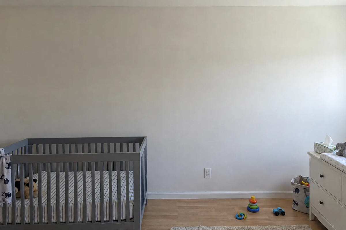 Gouache wall mural of a sleepy baby elephant and two meerkats, the same room before, by Whimsy Tots