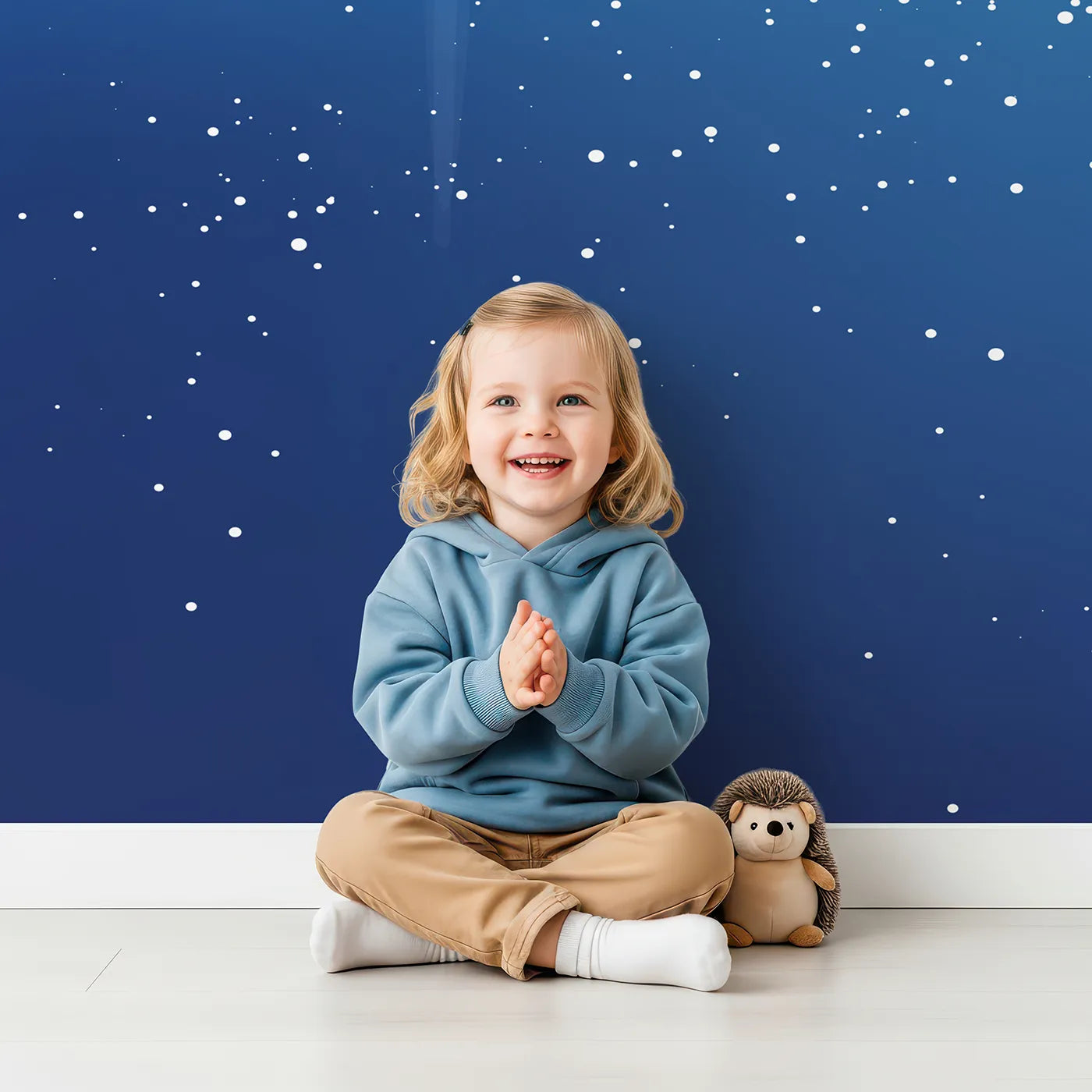 Child in front of Whimsy Tots Midnight Fireworks Celebration Wall Mural with fireworks, night, sky, star, celebration, sparkle, blue in design.