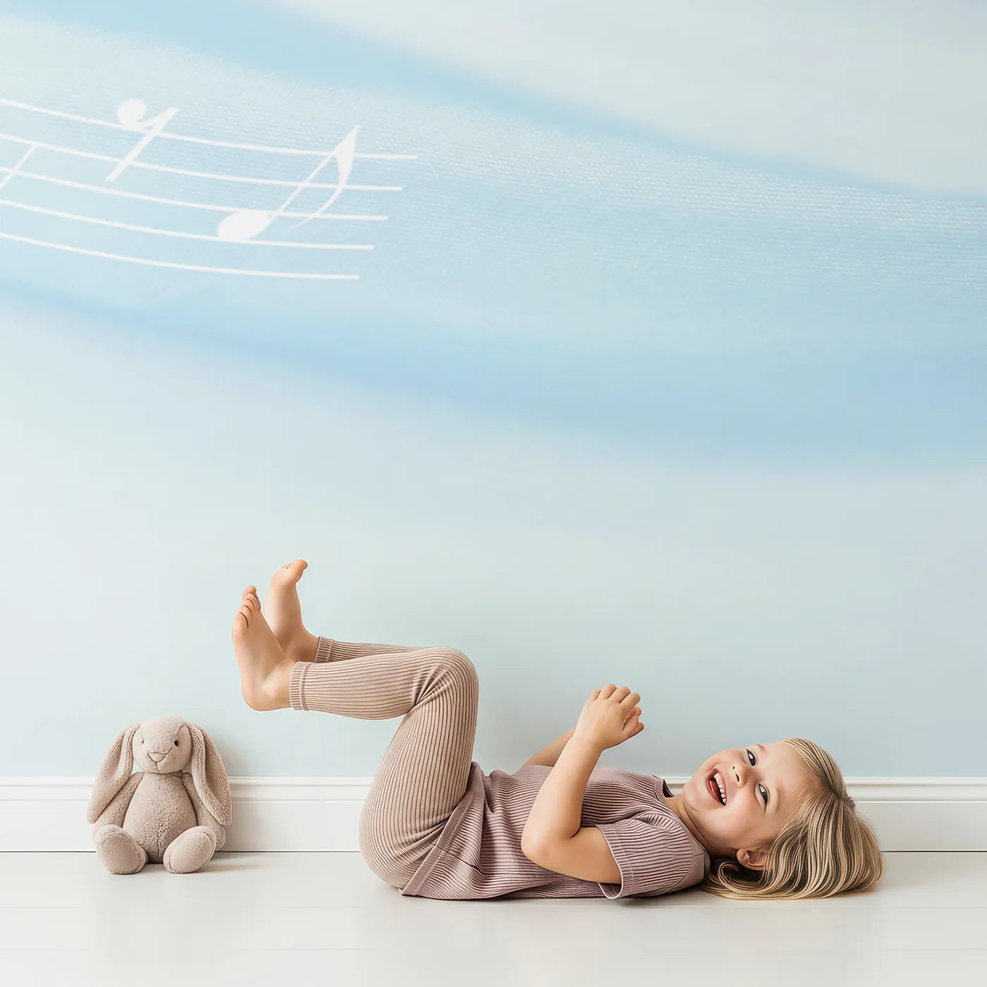 Child in front of Whimsy Tots Gentle Melody Wall Mural in Blue with music, note, blue, silk, soft, melody, gentle, calm in design.