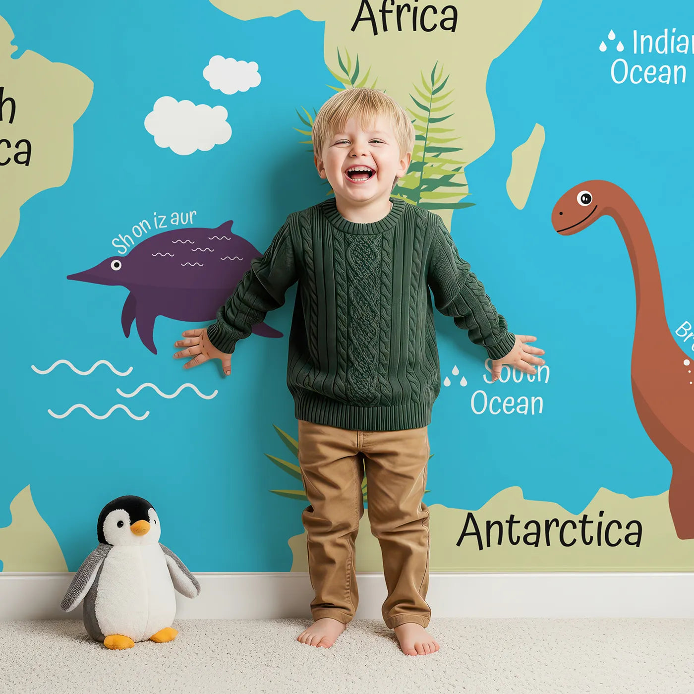 Child in front of Whimsy Tots Dinosaur World Map Wall Mural with dinosaur, map, world, animal, prehistoric, t-rex, stegosaurus, volcano in design.