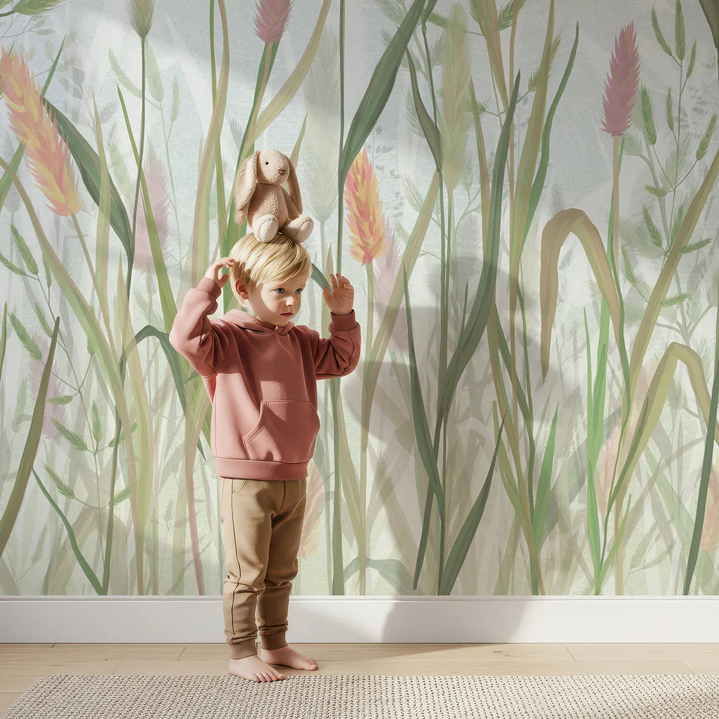 Child in front of Whimsy Tots Pastel Wild Grass Wall Mural with grass, wildflower, pastel, meadow, botanical, watercolor, pink, green in design.