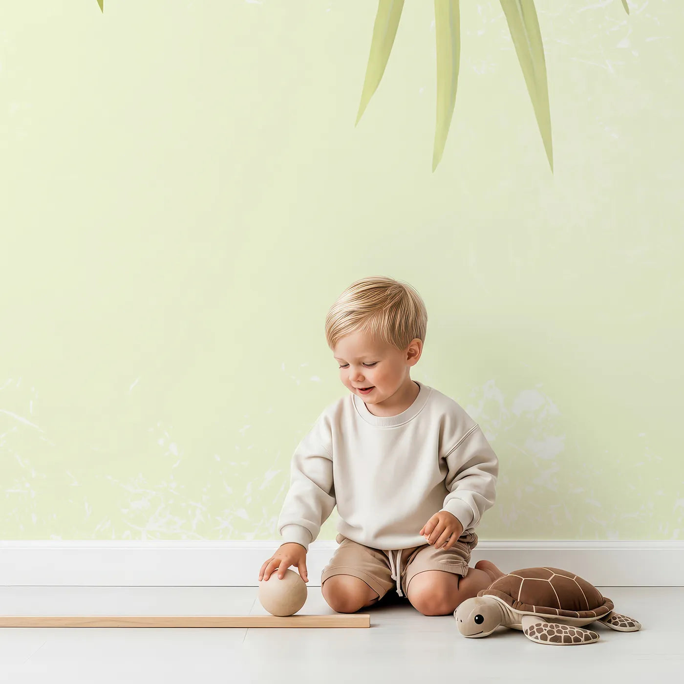 Child in front of Whimsy Tots Hanging Palm Leaves Wall Mural with leaf, palm, tropical, green, canopy, nature, botanical, jungle in design.