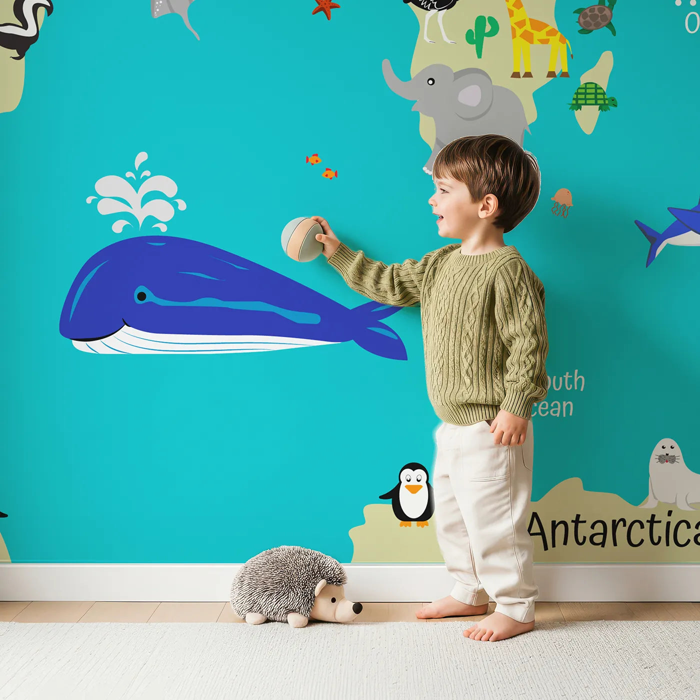 Child in front of Whimsy Tots World Wildlife Map Wall Mural in Teal with map, world, animal, wildlife, educational, cartoon, teal, ocean in design.