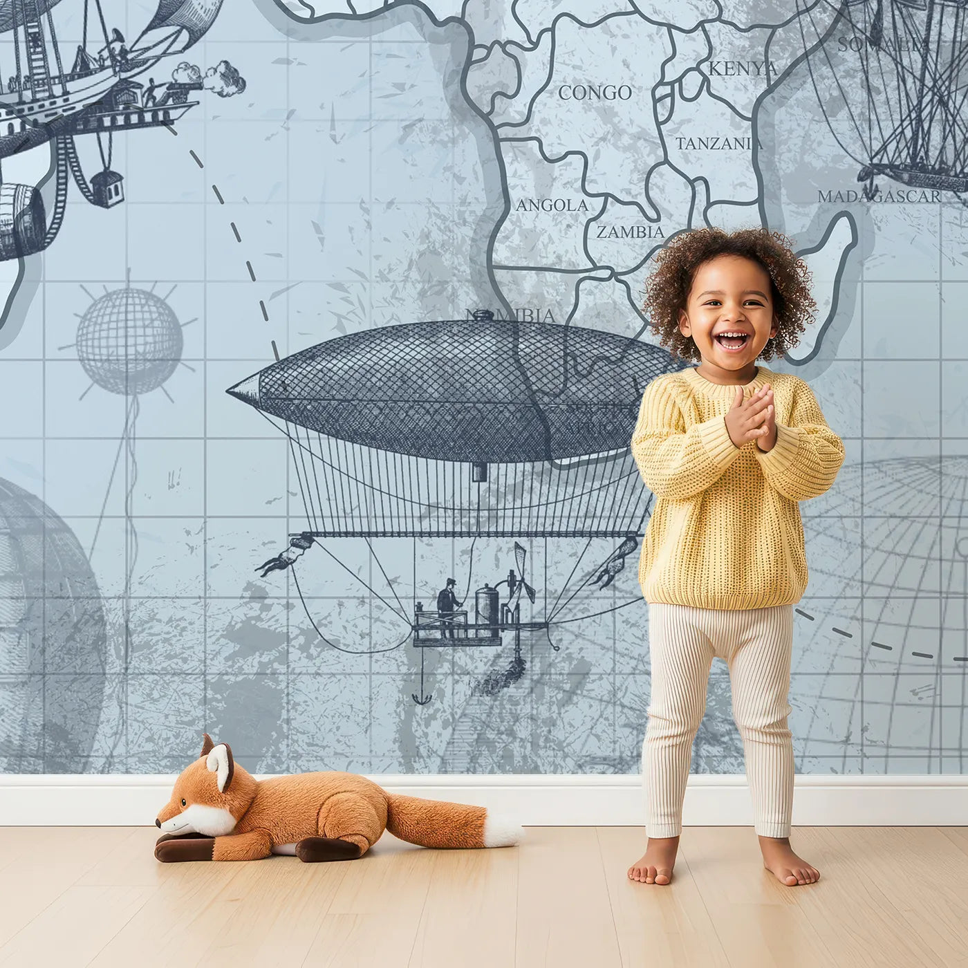 Child in front of Whimsy Tots Vintage Airship World Map Wall Mural with map, vintage, steampunk, airship, balloon, airplane, world, adventure in design.