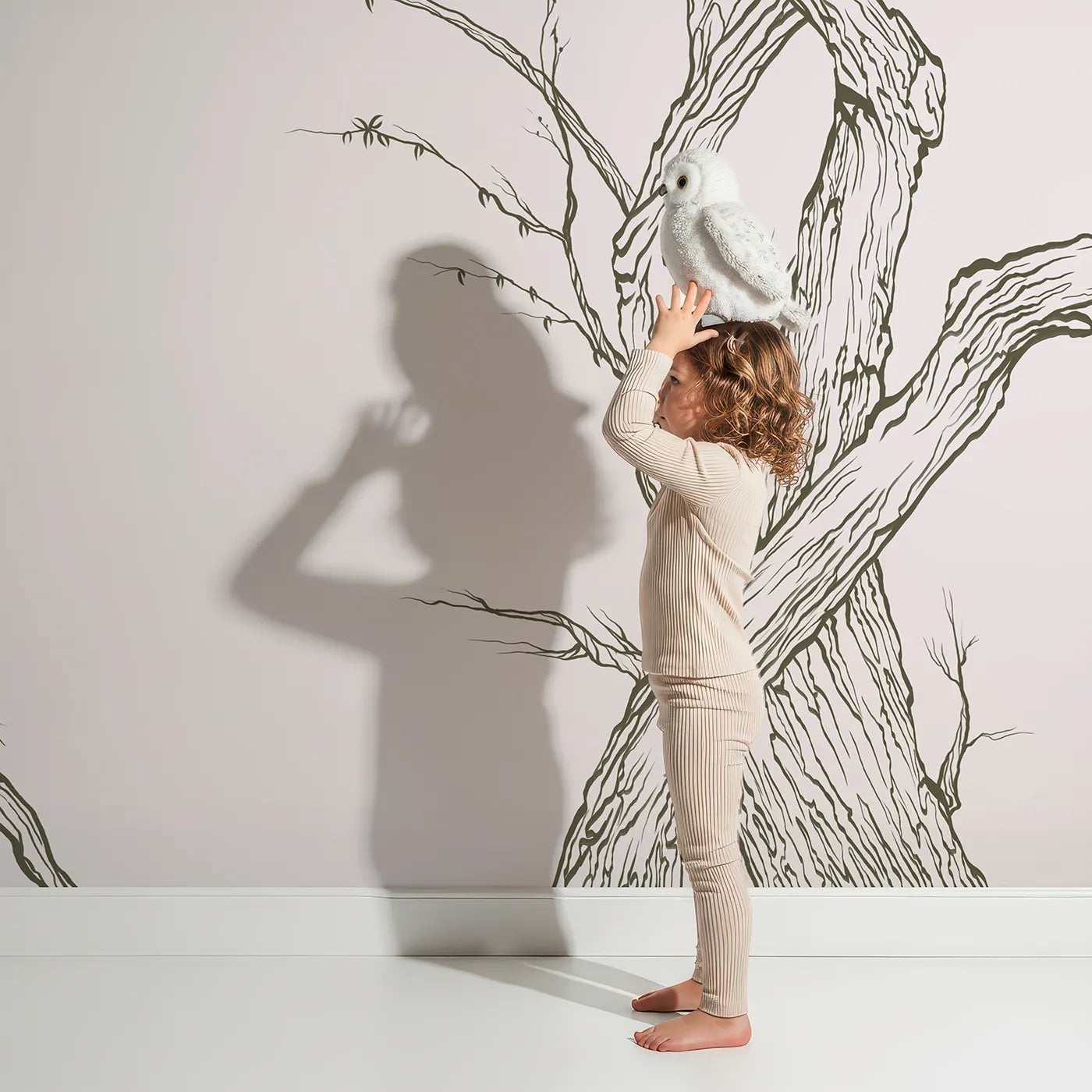 Child in front of Whimsy Tots Gnarled Tree Grove Wall Mural in Beige with tree, branch, sketch, line art, beige, nature, woods, ancient in design.