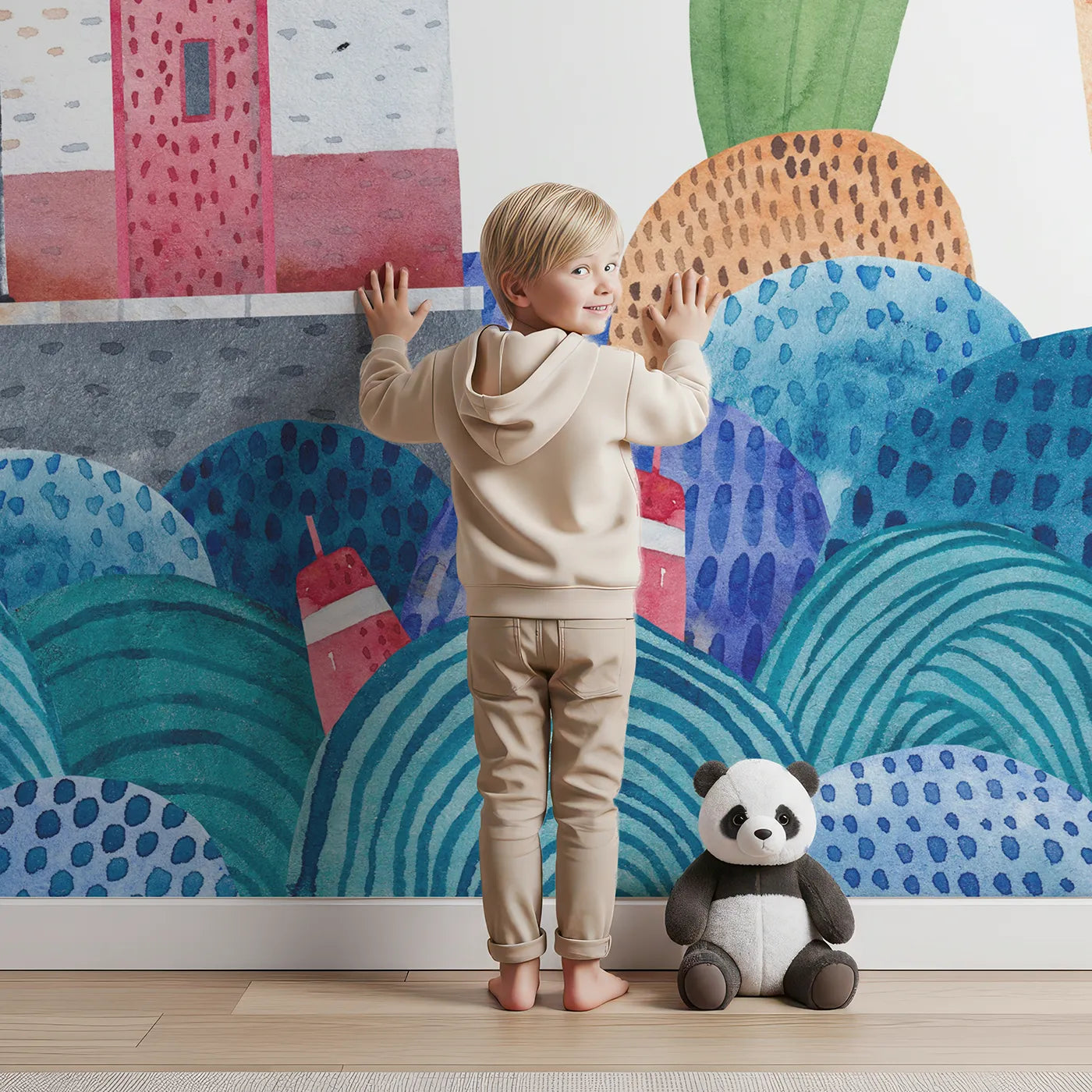 Child in front of Whimsy Tots Watercolor Harbor Adventure Wall Mural with harbor, boat, town, watercolor, sea, lighthouse, boy, whimsical in design.