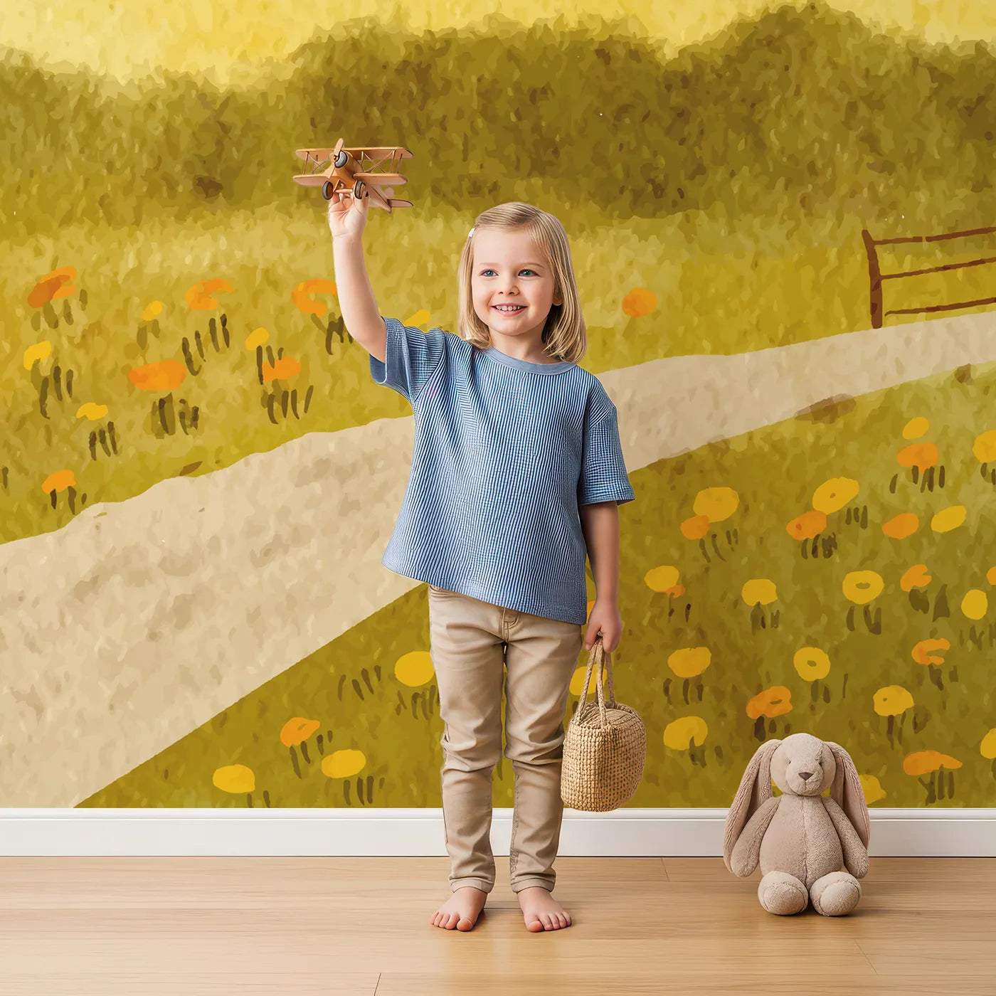 Child in front of Whimsy Tots Golden Meadow Path Wall Mural with meadow, landscape, watercolor, yellow, gold, path, field, flower in design.