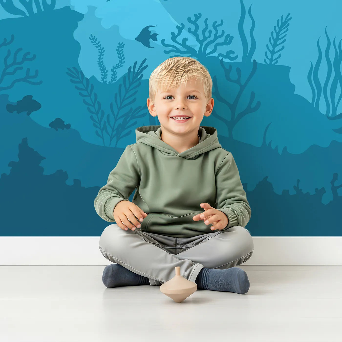 Child in front of Whimsy Tots Sunken Shipwreck Wall Mural with shipwreck, underwater, ocean, sea, silhouette, fish, shark, sunken in design.