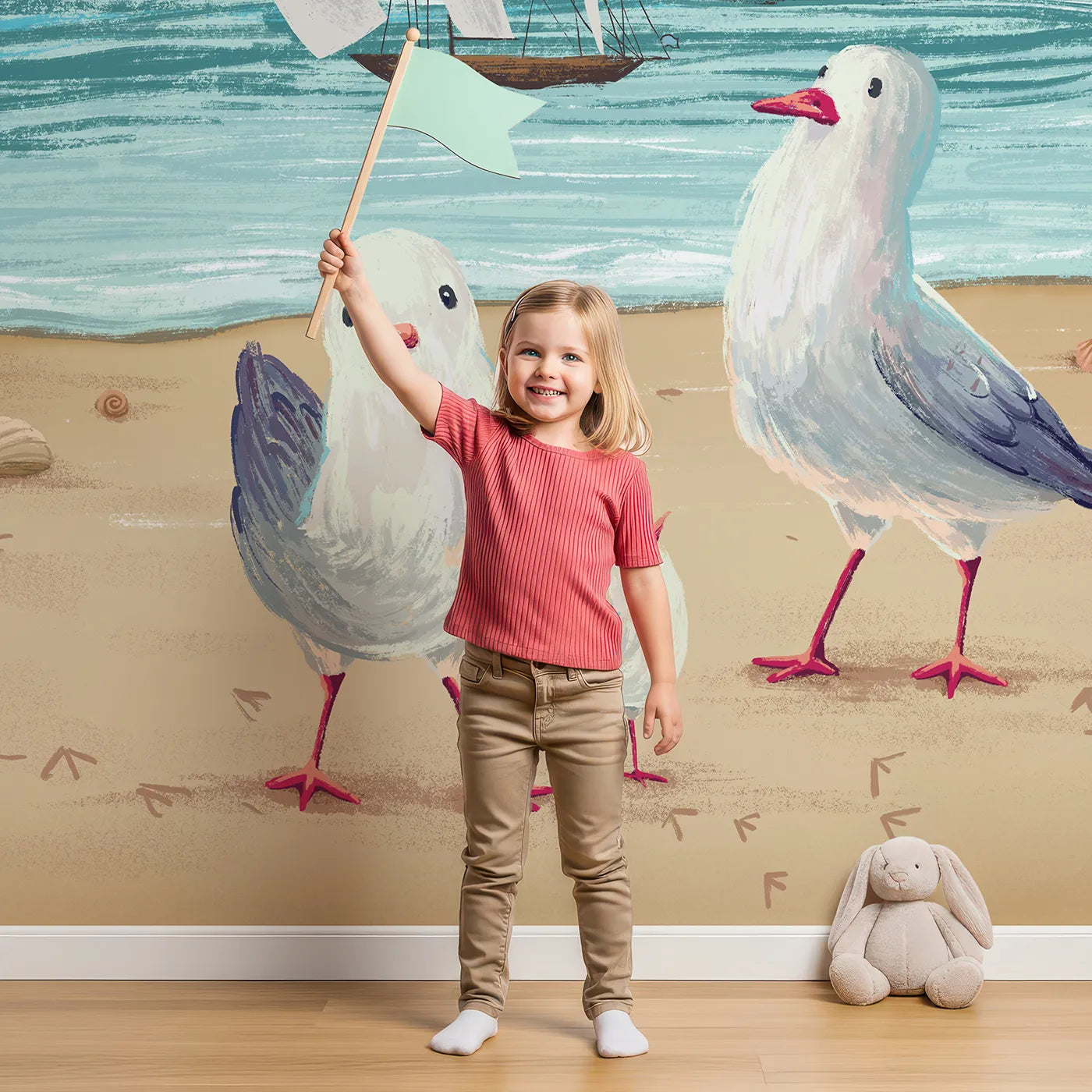 Child in front of Whimsy Tots Seagulls at the Seashore Wall Mural with seagull, beach, sea, ocean, boat, shell, sand, bird in design.