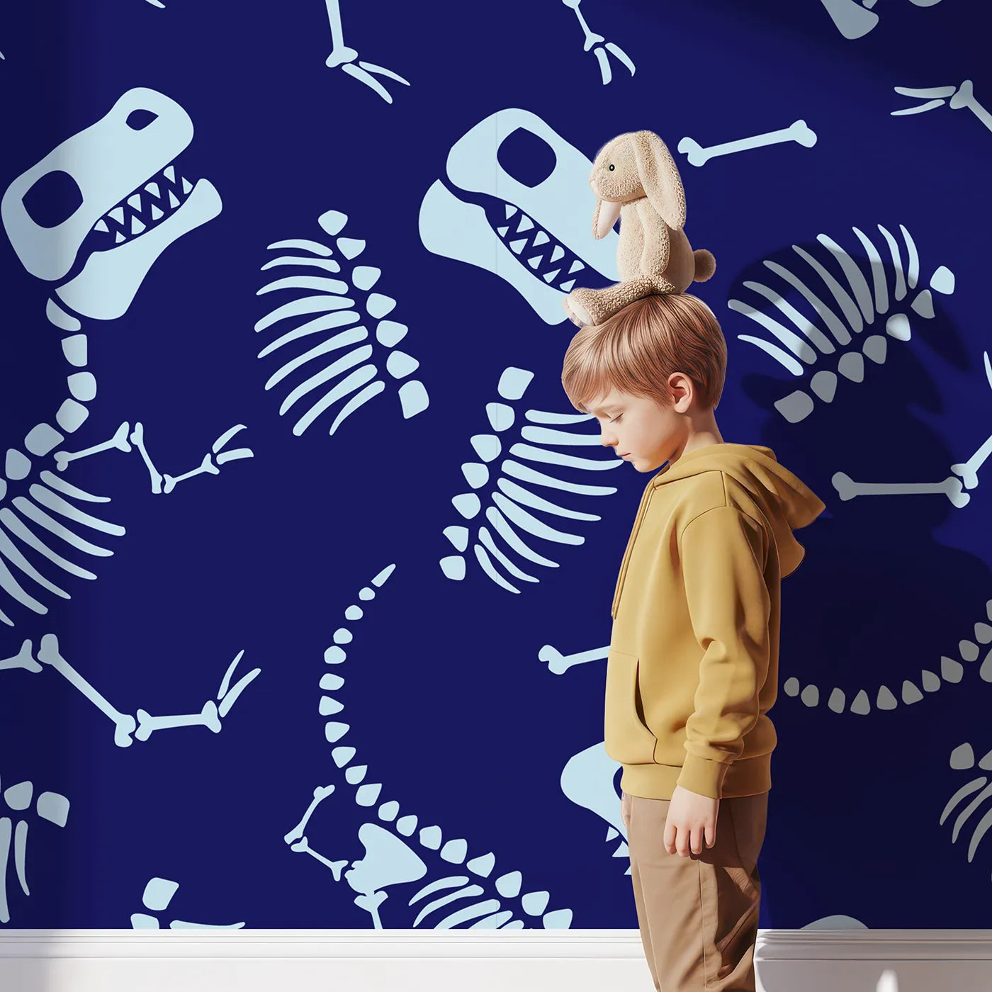 Child in front of Whimsy Tots Dinosaur Bones Wall Mural with dinosaur, skeleton, fossil, bone, t-rex, blue, prehistoric, science in design.