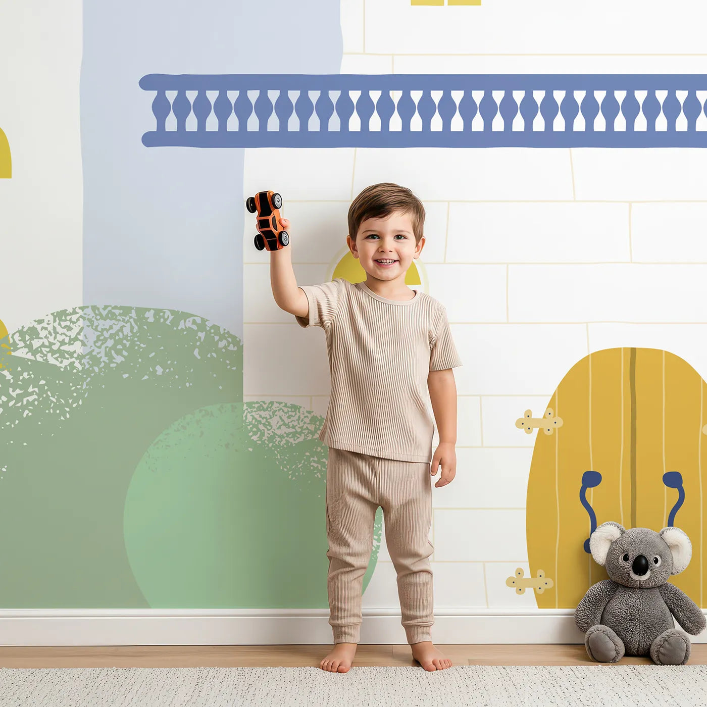 Child in front of Whimsy Tots Pastel Fairytale Castle Wall Mural with castle, rainbow, pastel, fairytale, simple, cute, pink, blue in design.