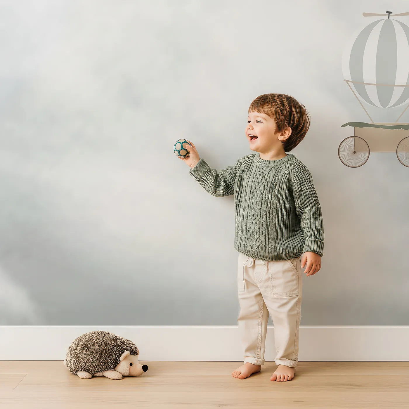 Child in front of Whimsy Tots Vintage Sky Adventure Wall Mural with airplane, balloon, vintage, cloud, sky, gray, retro, biplane in design.
