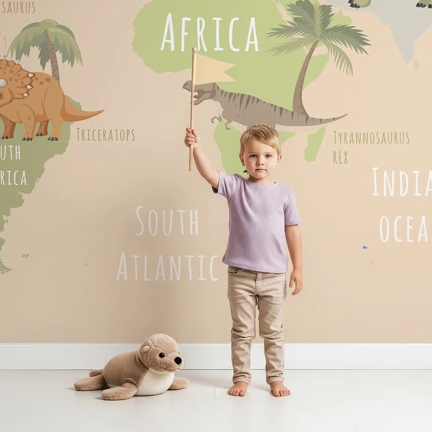 Child in front of Whimsy Tots Neutral Dinosaur World Map Wall Mural with dinosaur, map, world, educational, prehistoric, neutral, t-rex, science in design.
