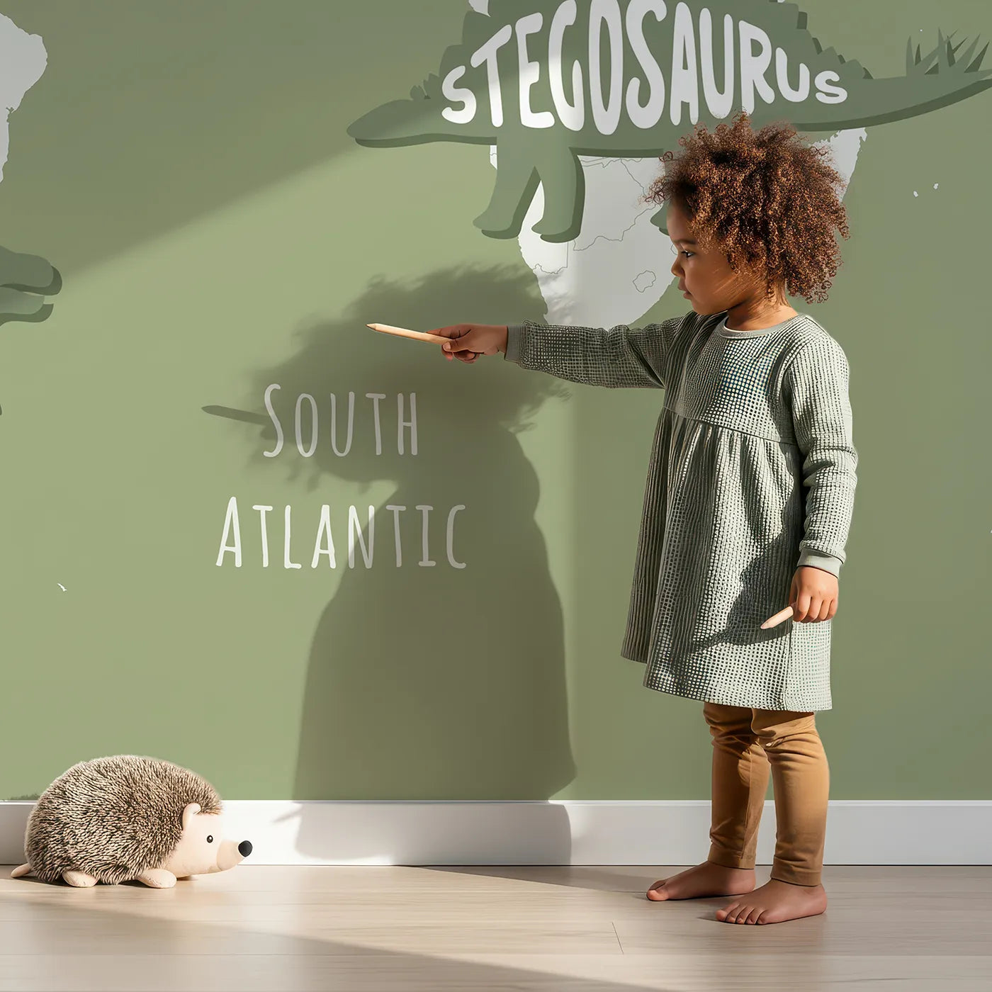 Child in front of Whimsy Tots Dinosaur Typography World Map Wall Mural with dinosaur, map, world, typography, name, educational, modern, silhouette in design.
