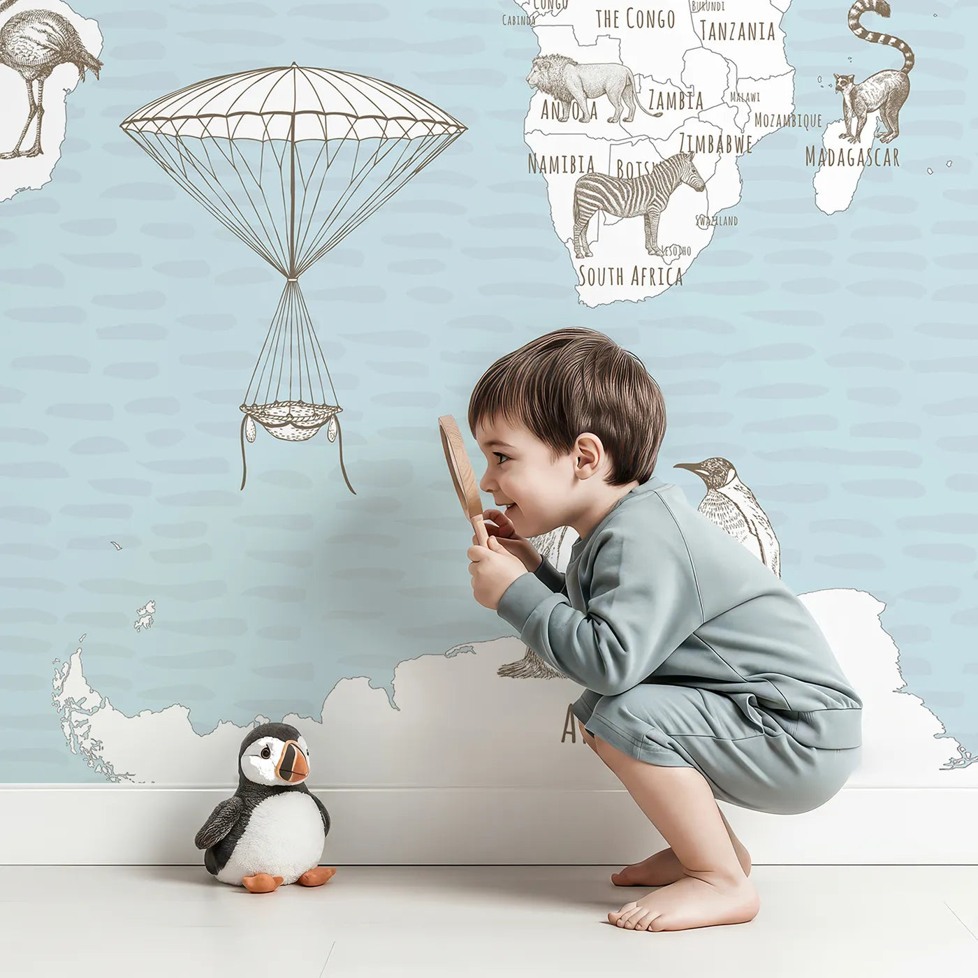 Child in front of Whimsy Tots Hand Drawn Animal World Map Wall Mural with map, world, animal, sketch, vintage, drawing, travel, educational in design.