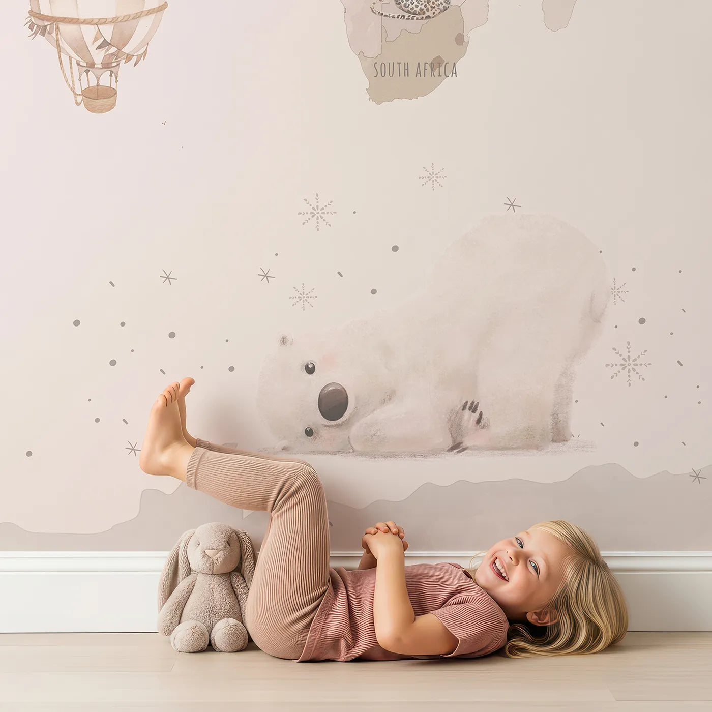 Child in front of Whimsy Tots Watercolor World Adventure Wall Mural with map, world, watercolor, pink, animal, airplane, travel, vintage in design.