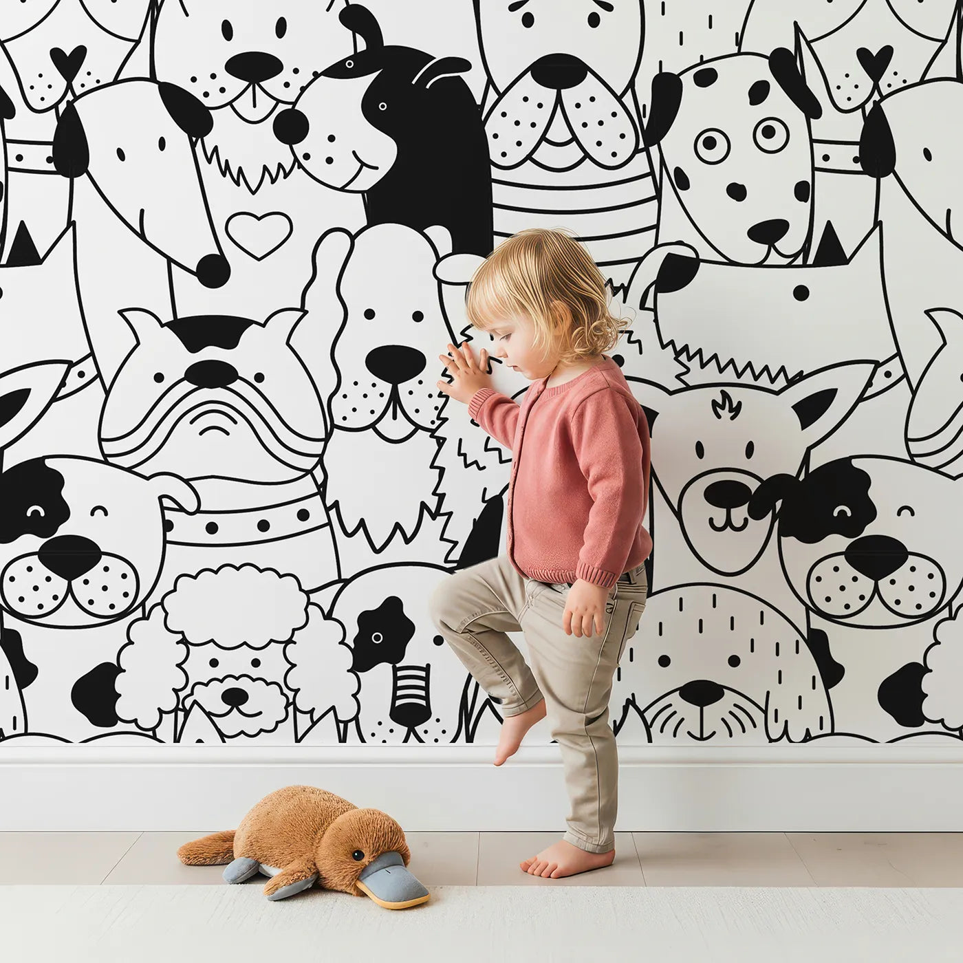 Child in front of Whimsy Tots Doodle Dog Party Wall Mural with dog, puppy, doodle, black and white, pattern, cute, animal, face in design.