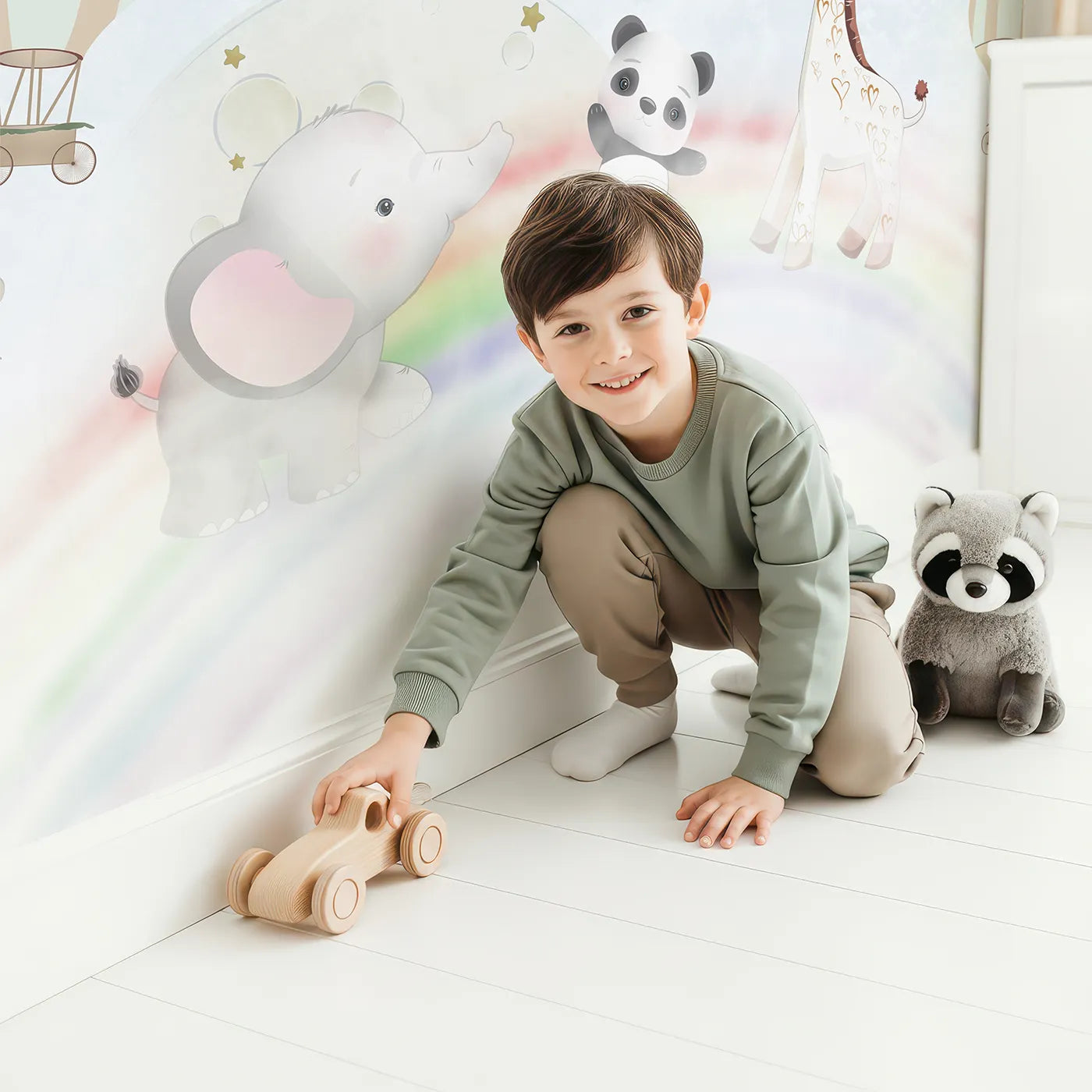 Child in front of Whimsy Tots Starry Rainbow Adventure Wall Mural with animal, safari, rainbow, cute, sky, star, balloon, airplane in design.
