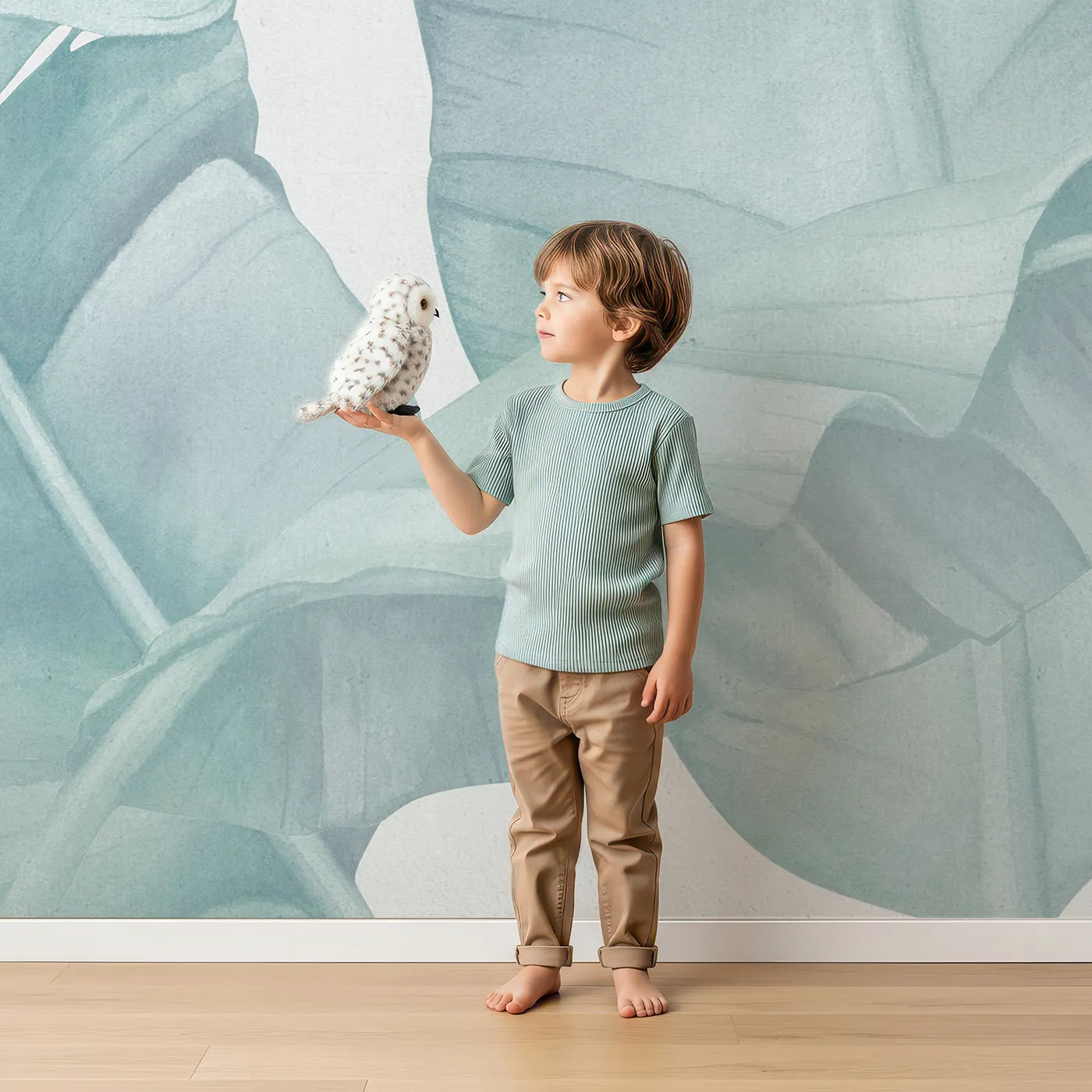 Child in front of Whimsy Tots Teal Banana Leaf Wall Mural with leaf, banana, tropical, teal, green, translucent, modern, minimalist in design.