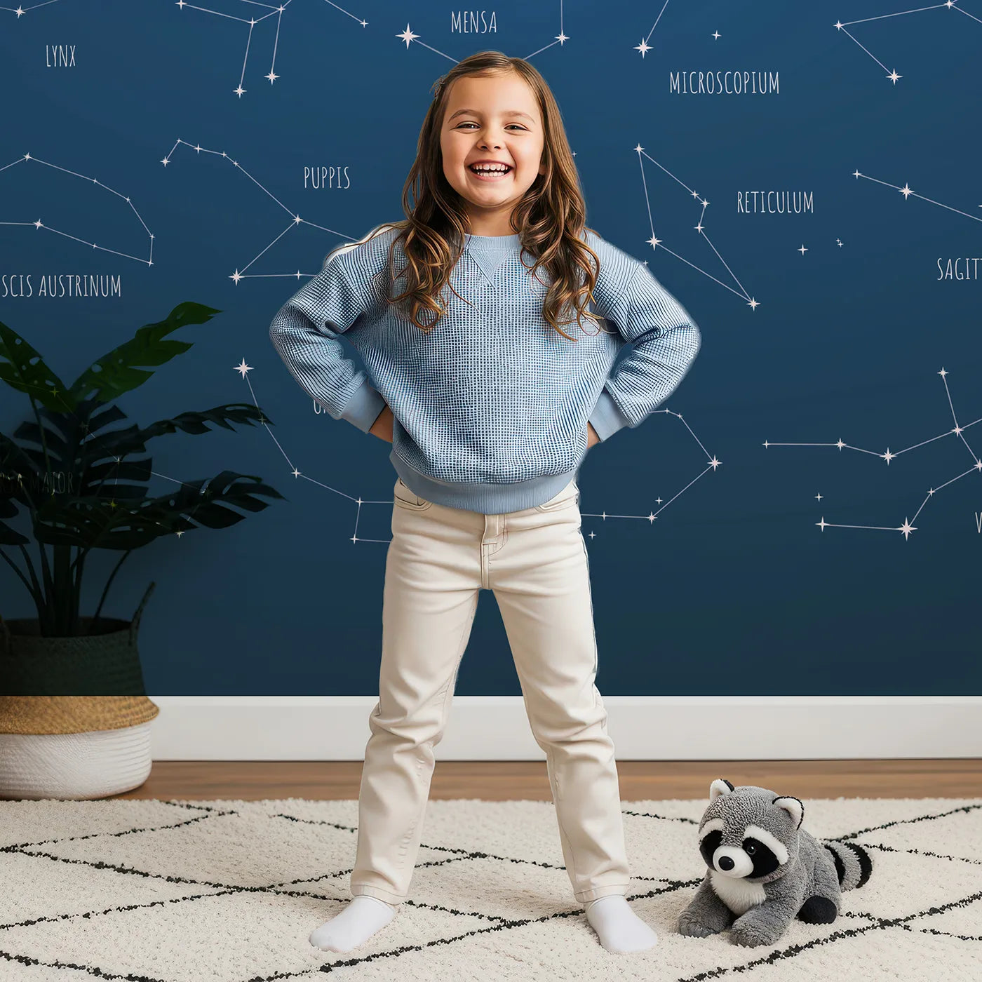 Child in front of Whimsy Tots Constellation Chart Wall Mural with constellation, star, space, science, astronomy, chart, map, educational in design.