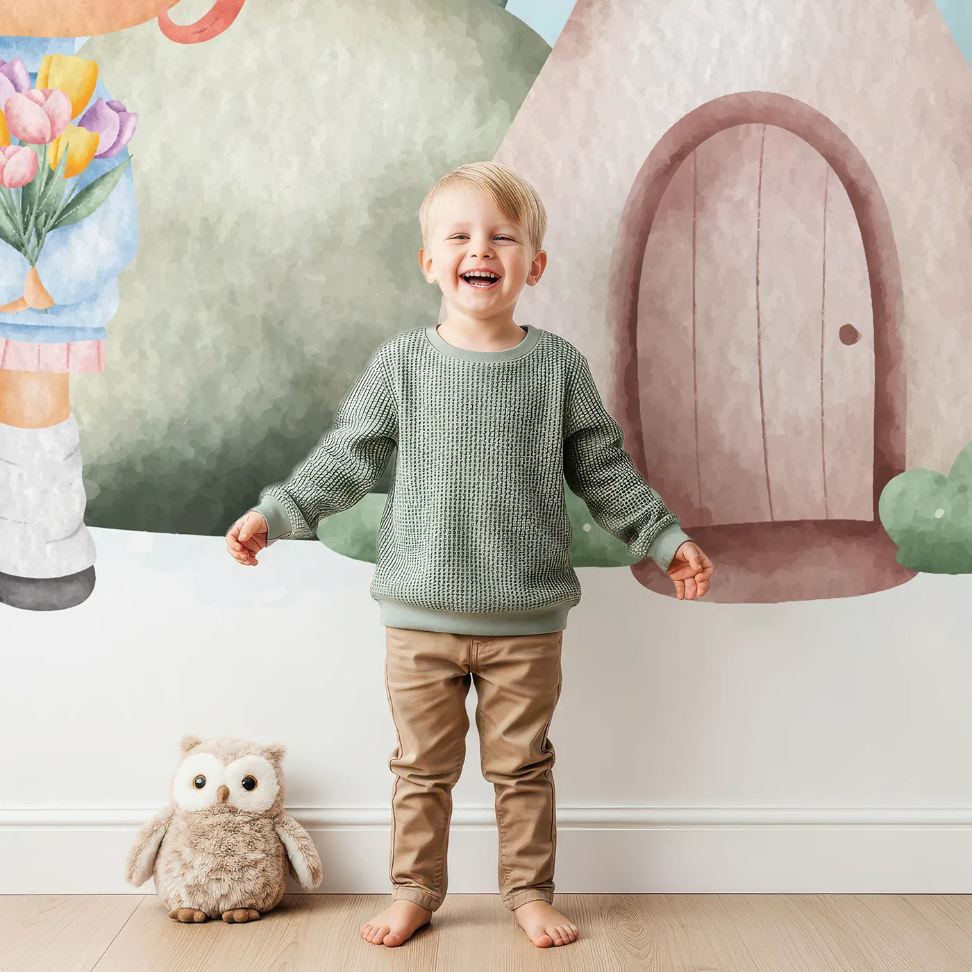 Child in front of Whimsy Tots Mushroom House Fairy Wall Mural with mushroom, house, girl, cute, watercolor, fairytale, snail, flower in design.