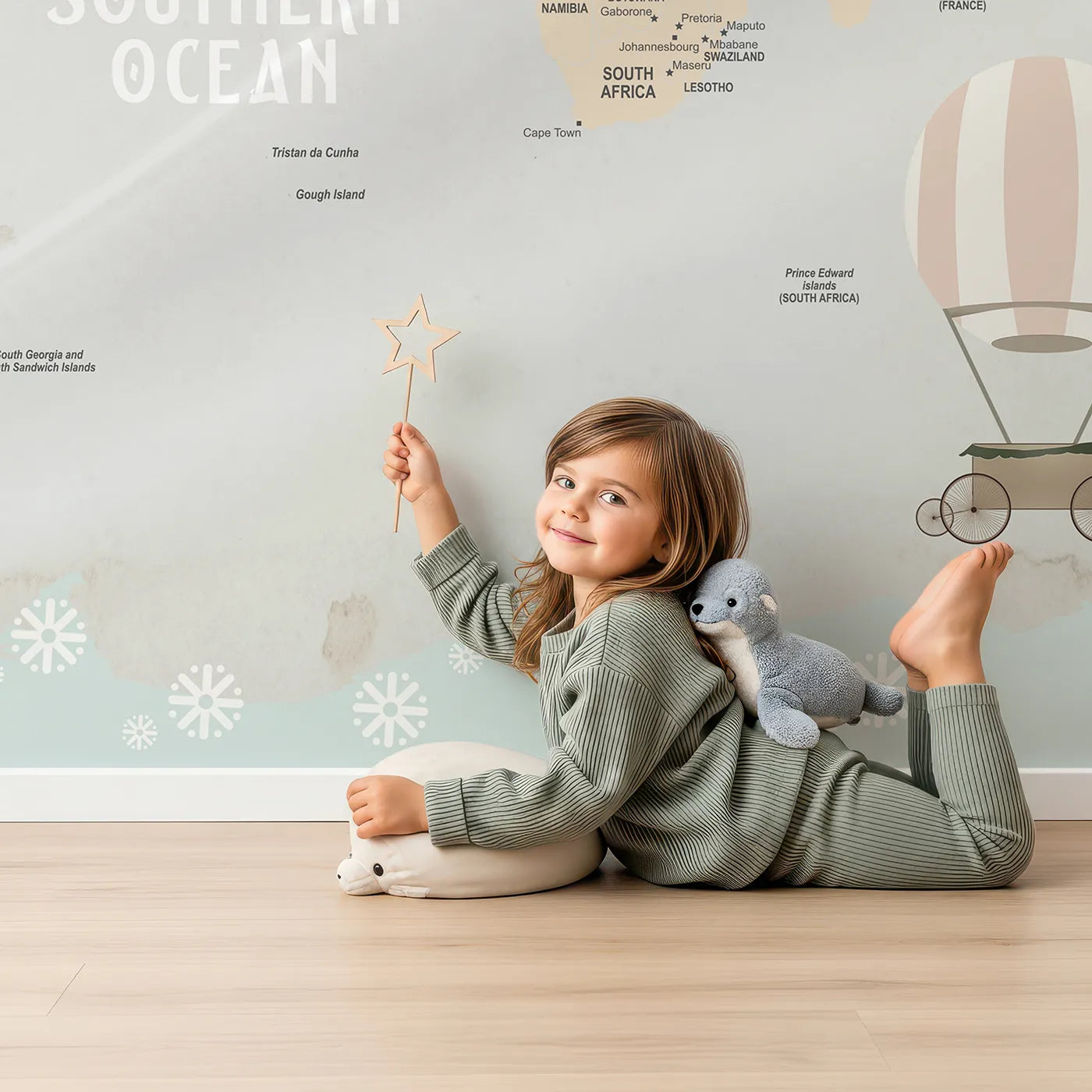 Child in front of Whimsy Tots Animal Hot Air Balloon World Map Wall Mural with map, world, animal, balloon, vintage, travel, educational, safari in design.