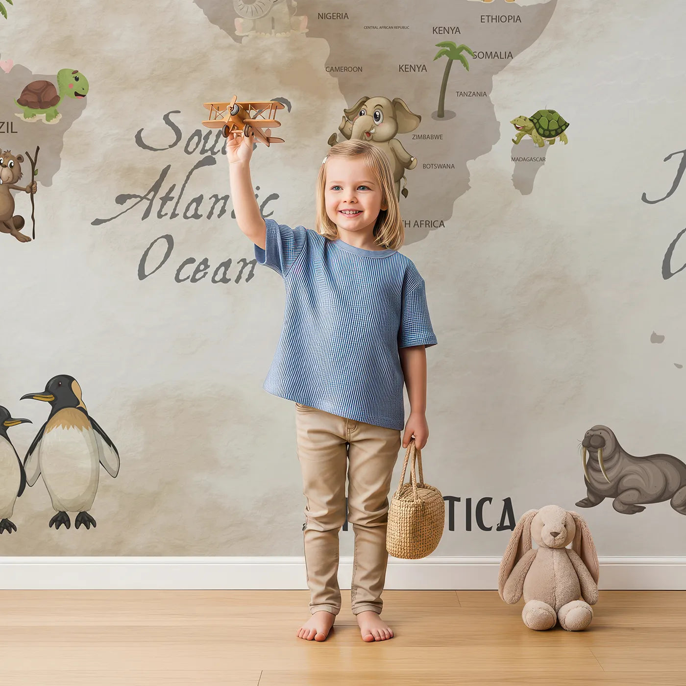 Child in front of Whimsy Tots Vintage Animal World Map Wall Mural with map, world, animal, vintage, drawing, educational, travel, classic in design.