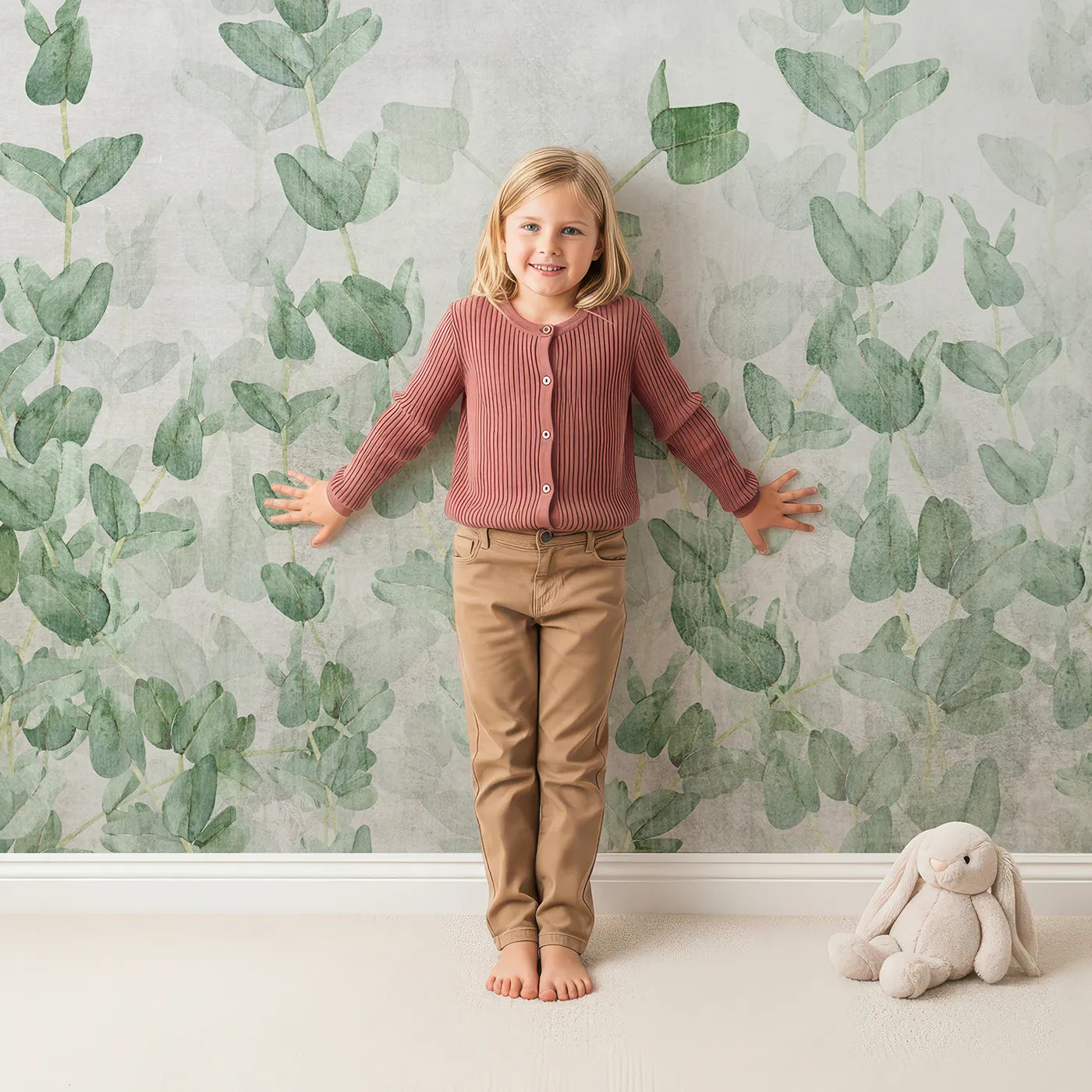 Child in front of Whimsy Tots Eucalyptus Grove Wall Mural with eucalyptus, leaf, green, botanical, rustic, grunge, vintage, calm in design.