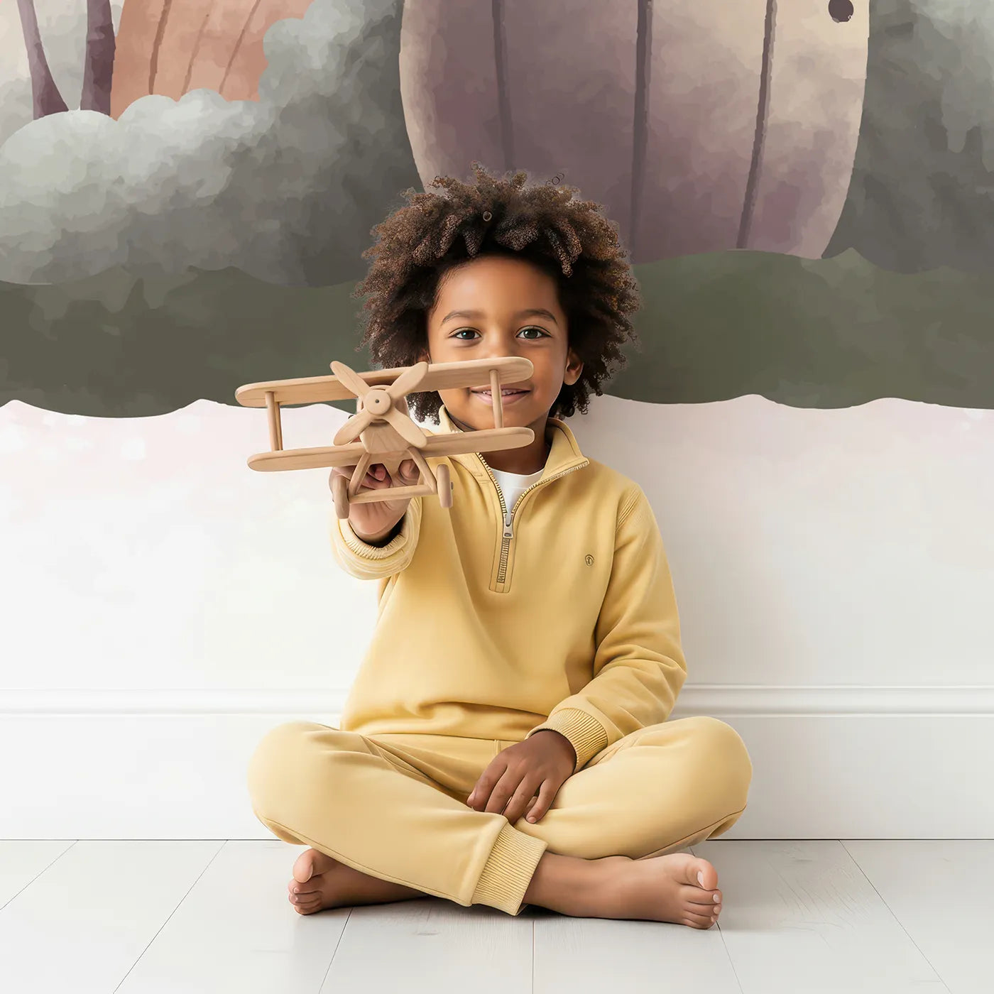 Child in front of Whimsy Tots Fairy Mushroom House Wall Mural in Beige with fairy, mushroom, house, cute, watercolor, fairytale, beige, magical in design.