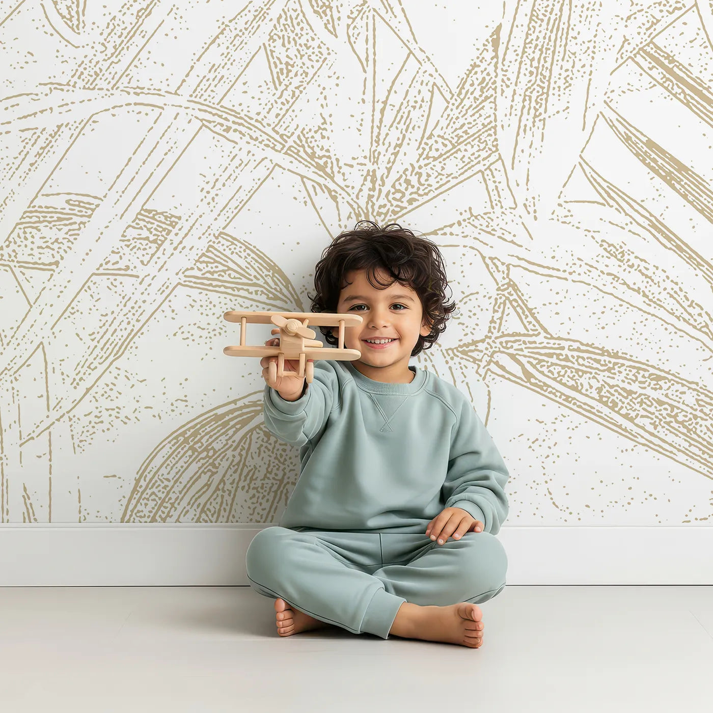 Child in front of Whimsy Tots Golden Bamboo Line Art Wall Mural with bamboo, leaf, line art, engraving, gold, beige, garden, pattern in design.