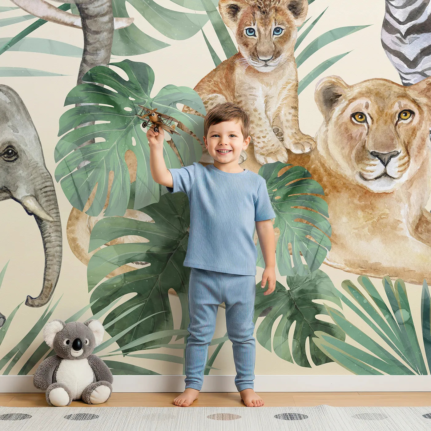 Child in front of Whimsy Tots Watercolor Safari Gathering Wall Mural with safari, animal, jungle, watercolor, elephant, lion, giraffe, realistic in design.